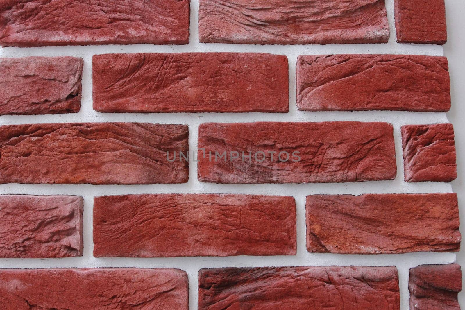 Photo texture red brick and white seams. The texture of the wall. Facing material. Walls of houses.