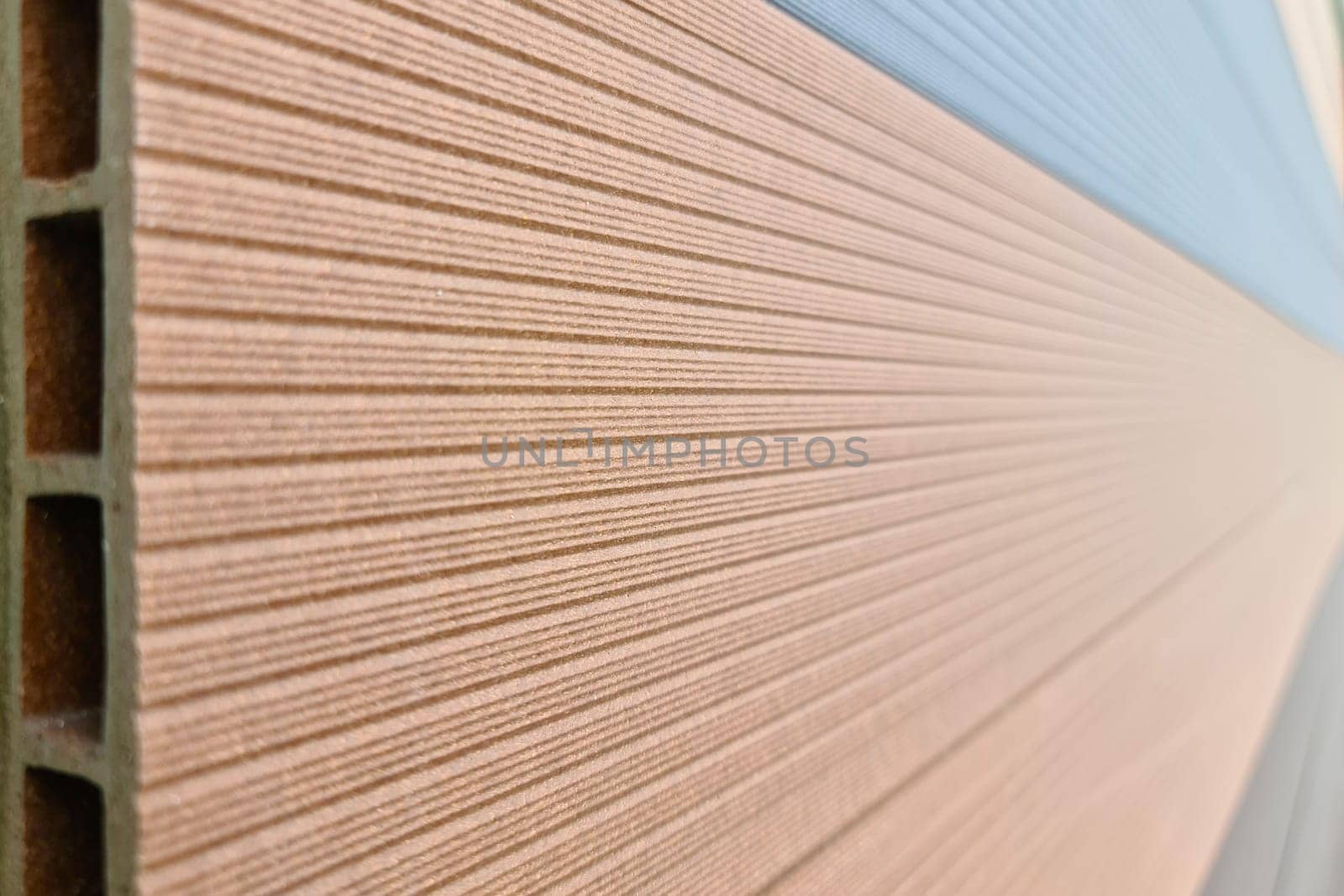 WPC terrace board, wood plastic composite decking boards in hardware store, close-up by Rom4ek