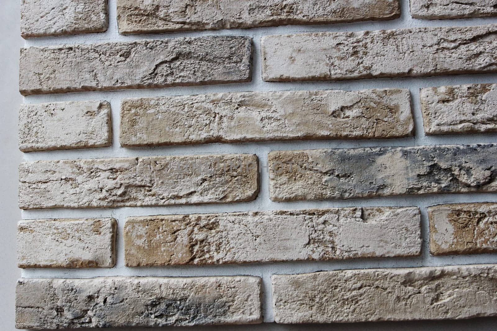 Photo texture yellow brick and white seams. The texture of the wall. Facing material. Walls of houses.