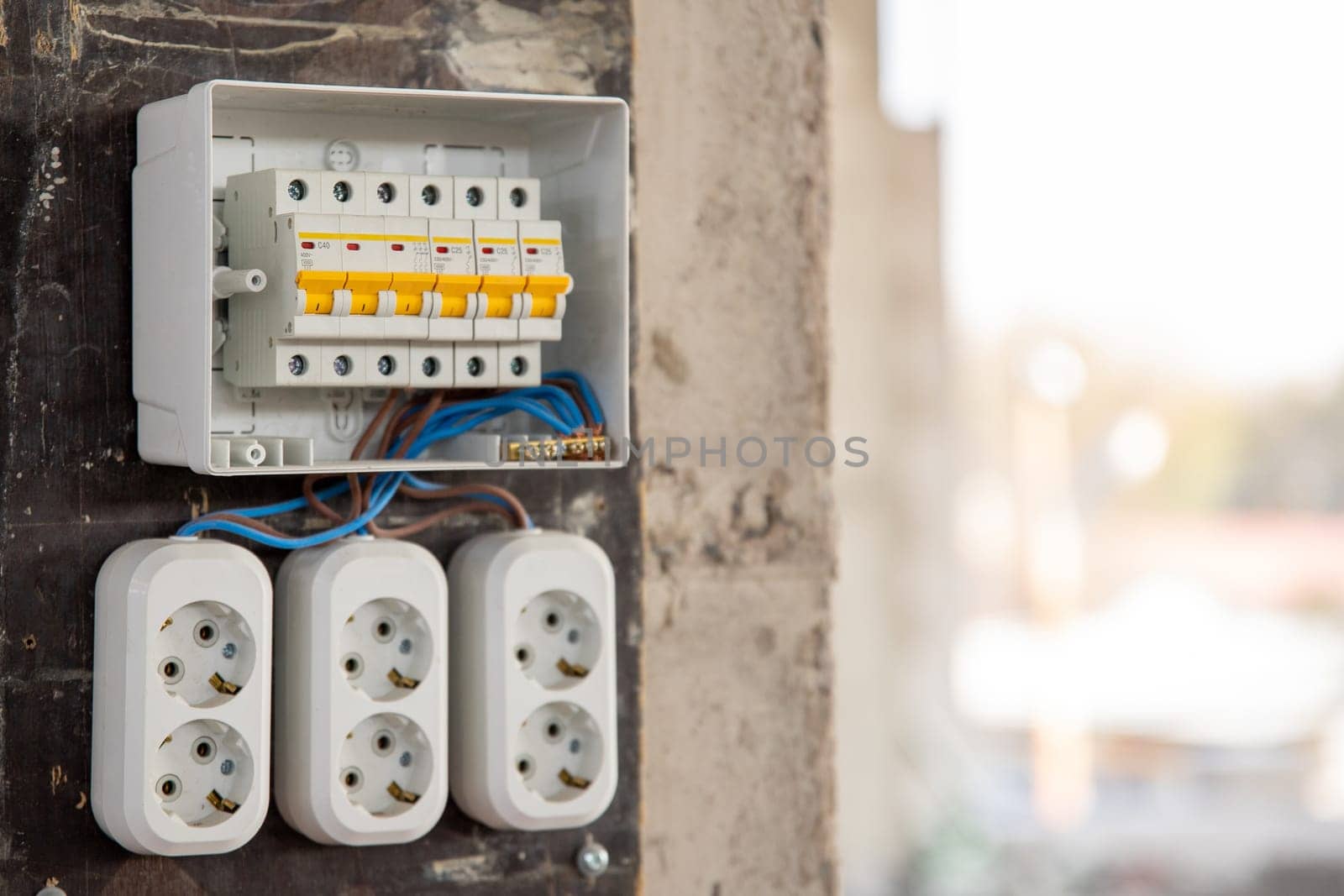 Temporary electrical distribution board with sockets on a construction site.