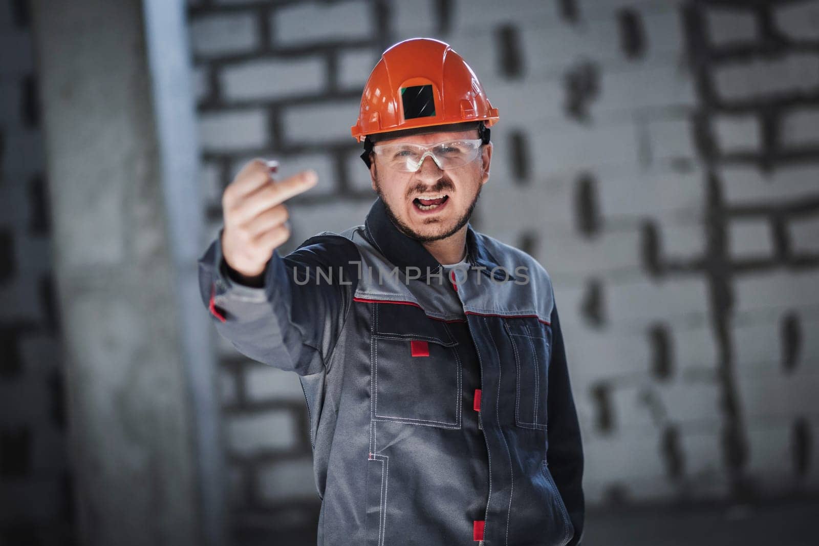 Portrait of an emotional angry construction worker.