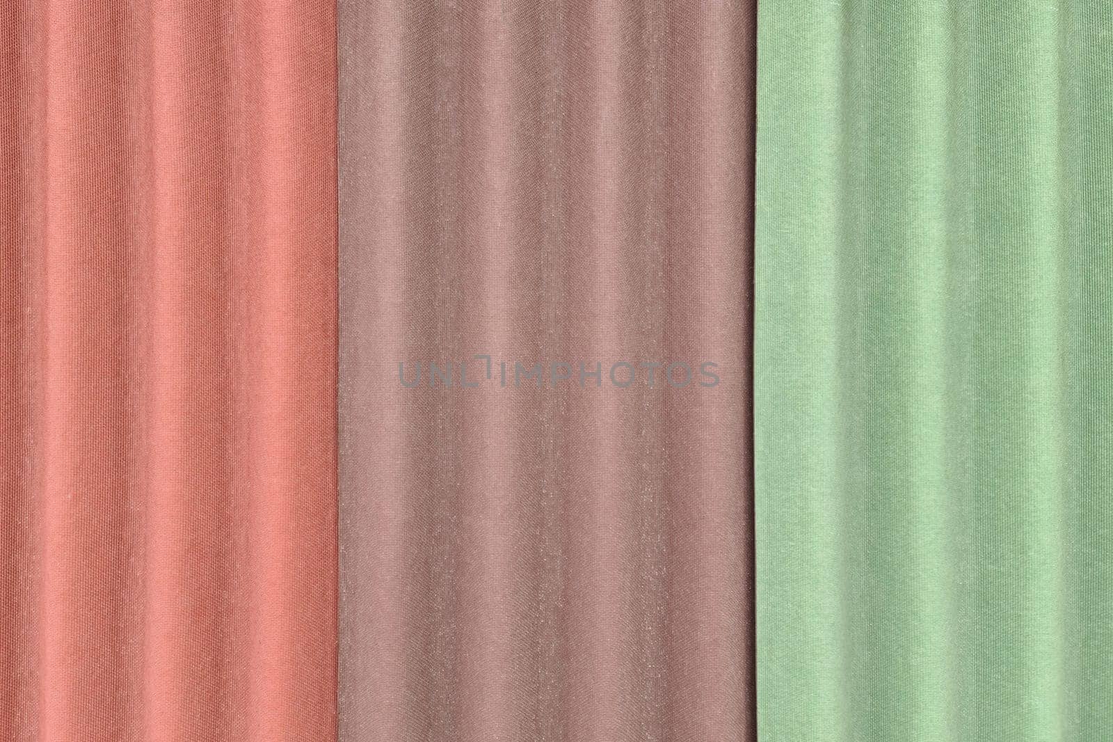Background with three sheets of ondulin of different colors. Modern cheap roofing material, top view.