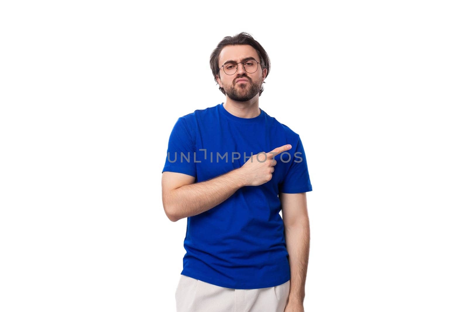 young brunette european man with a beard in a blue t-shirt is inspired by an idea on a white background with copy space.