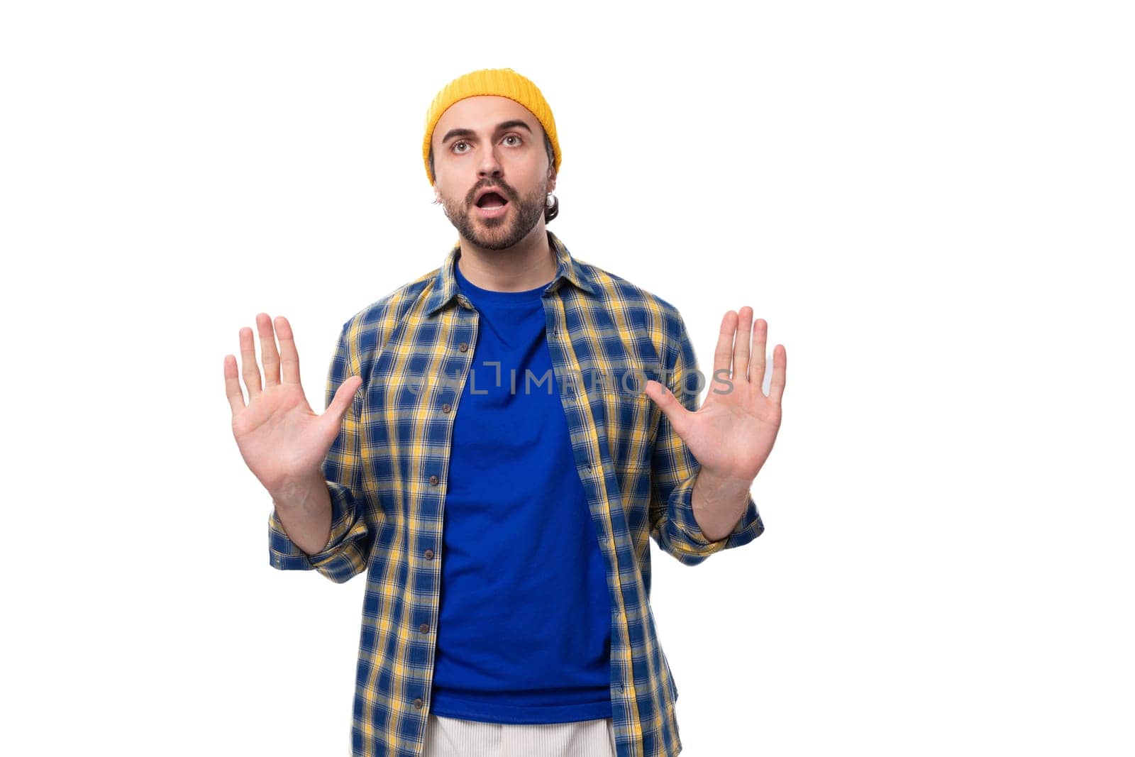 young attractive caucasian brunette handsome guy with a well-groomed beard and mustache in a plaid shirt.