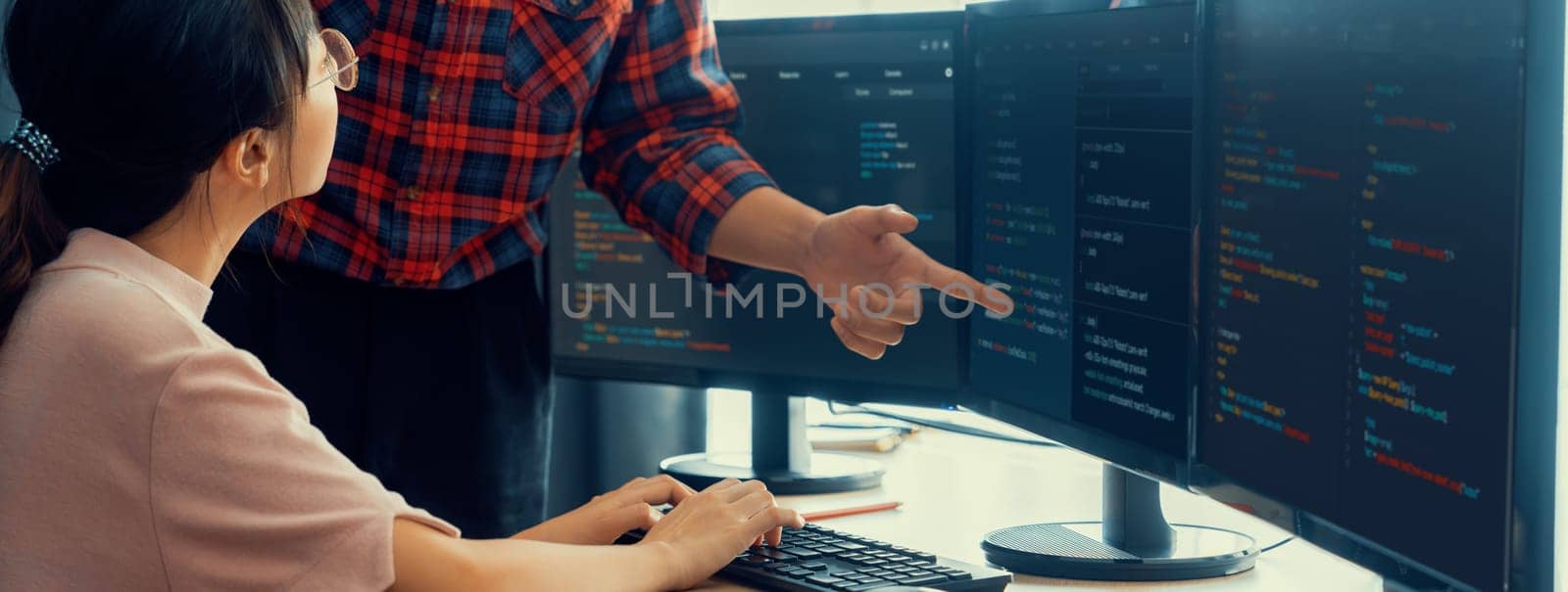 Cropped image of professional programer team collaboration discuss about web coding while coworker point java script displayed on computer at modern company office. Closeup. Burgeoning.