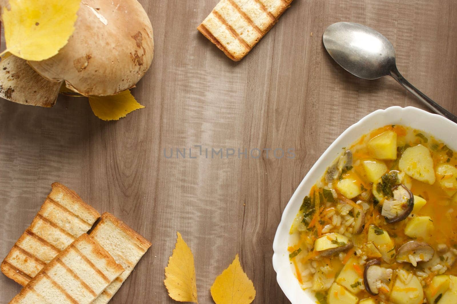 Mushroom soup in a white bowl on a beige background. High quality photo