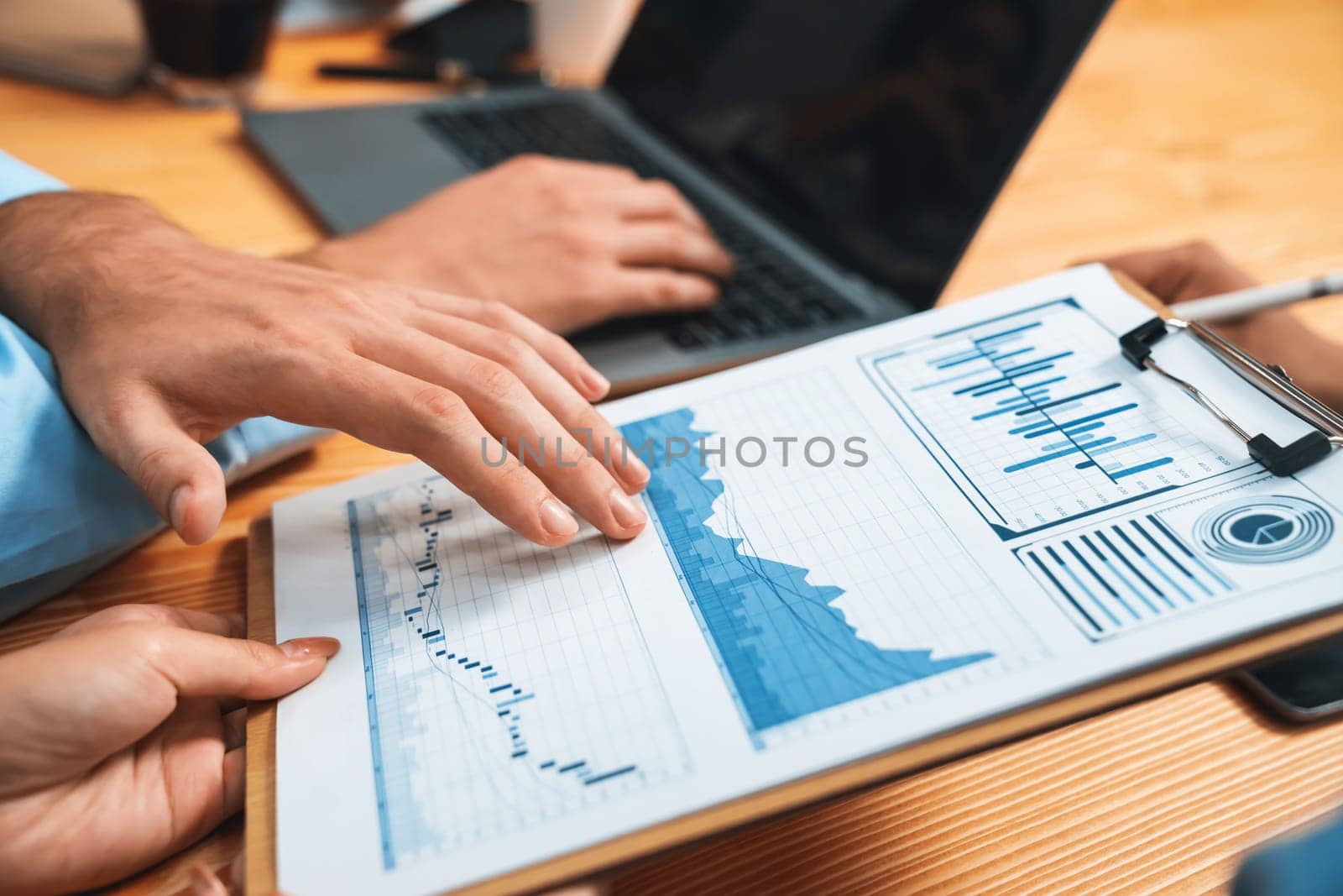 Top view diverse group of business analyst team analyzing financial data report paper on meeting table. Chart and graph dashboard by business intelligence analysis. Meticulous
