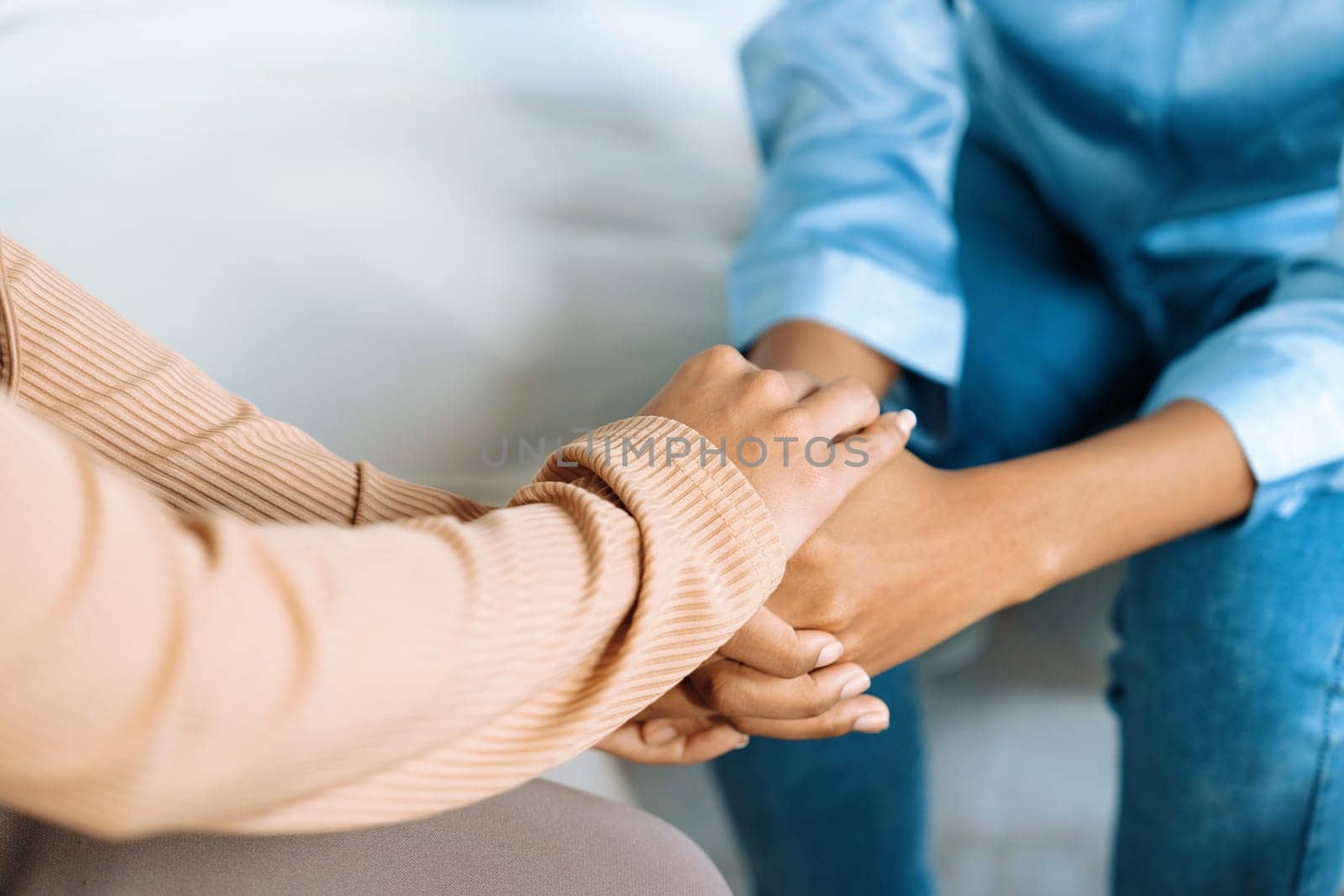 Close up shot of supportive and comforting hands for crucial empathy by biancoblue