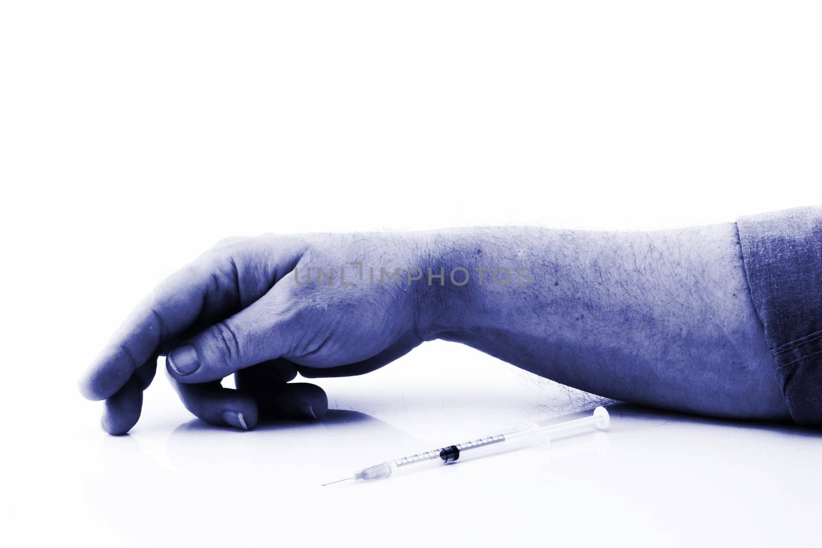 Addiction syringe and blue arm by VivacityImages