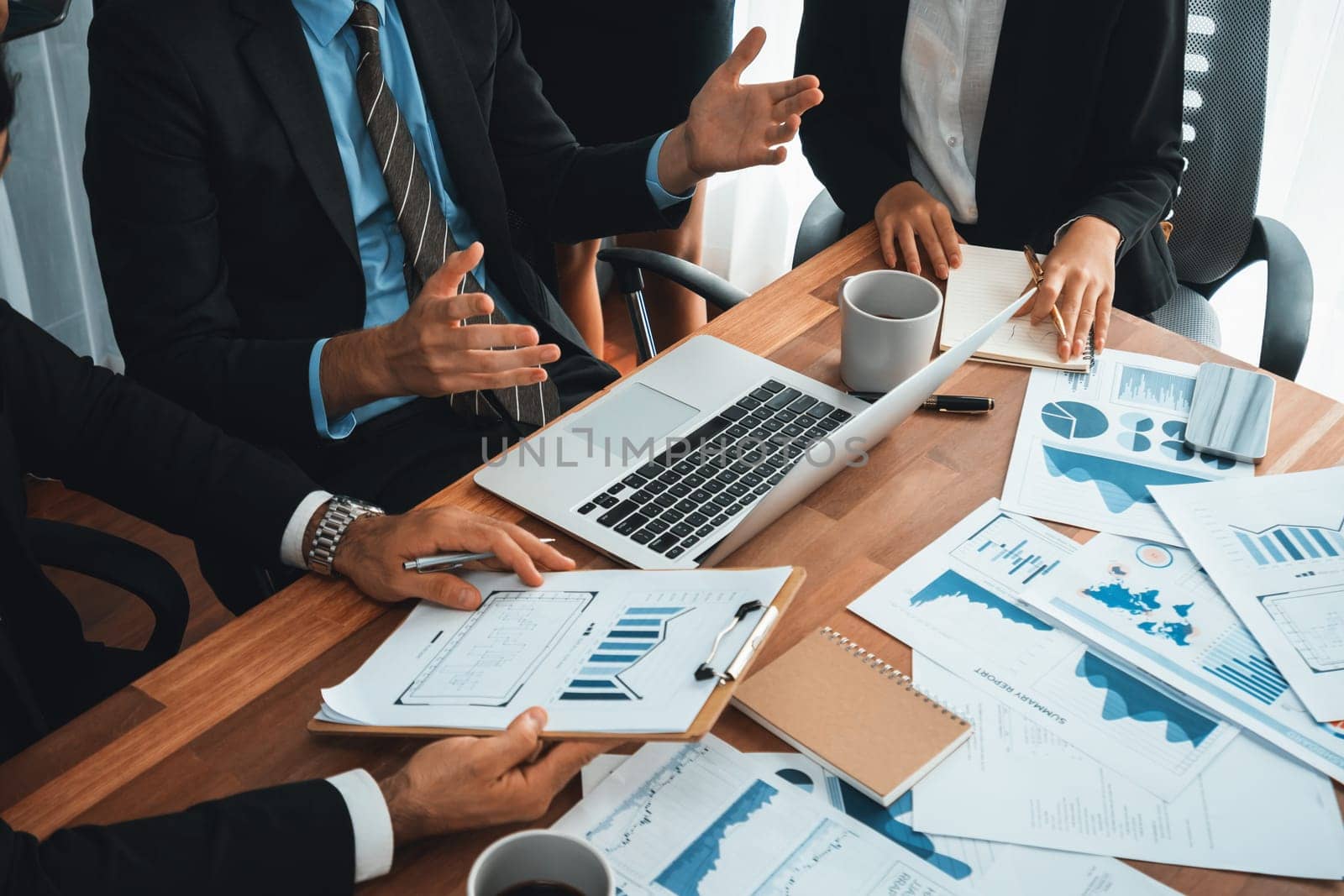 Diverse group of business analyst team analyzing financial data report paper on office table. Chart and graph dashboard by business intelligence analysis for strategic marketing planning Habiliment