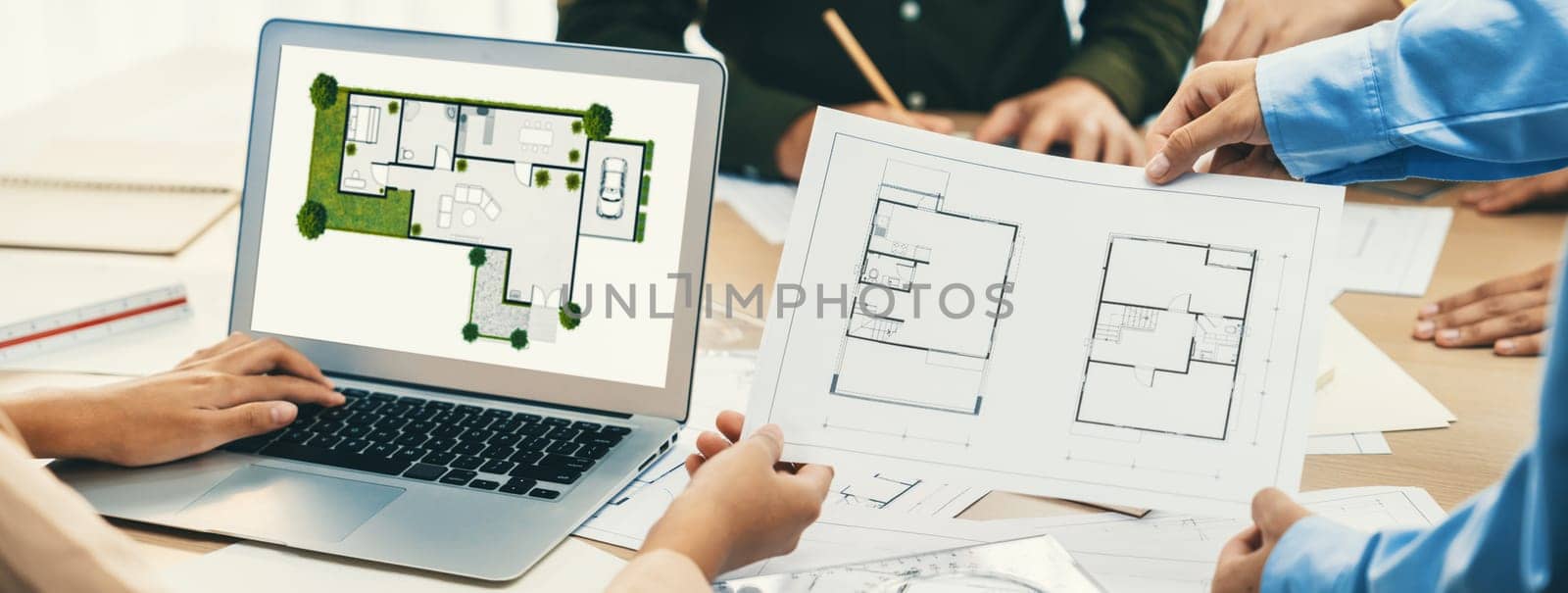 Professional architect decide the blueprint for eco-friendly house during discussion about changing blueprint plan at meeting table with architectural document scatter around. Closeup. Delineation