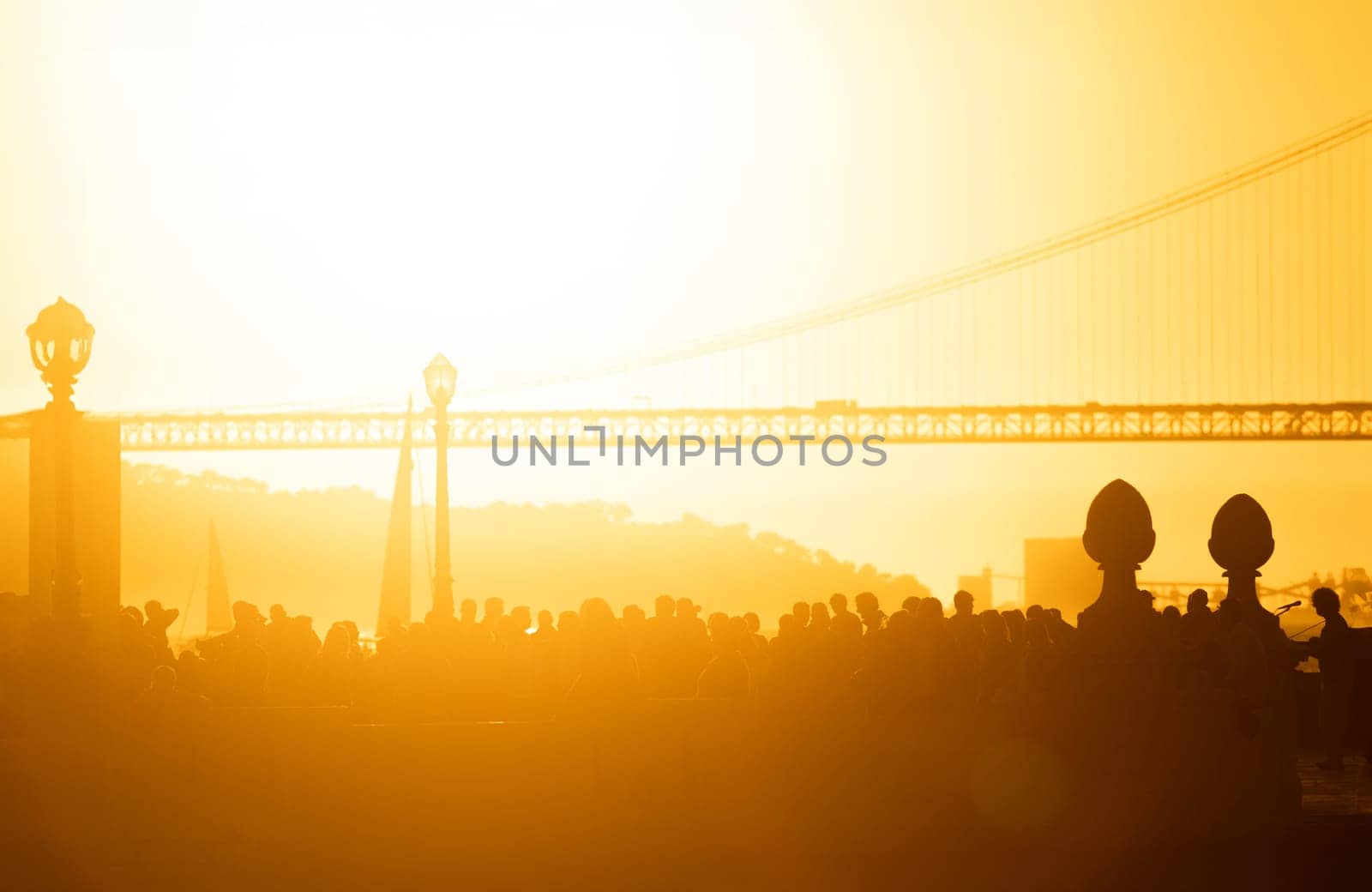 A group of people standing in front of a bridge