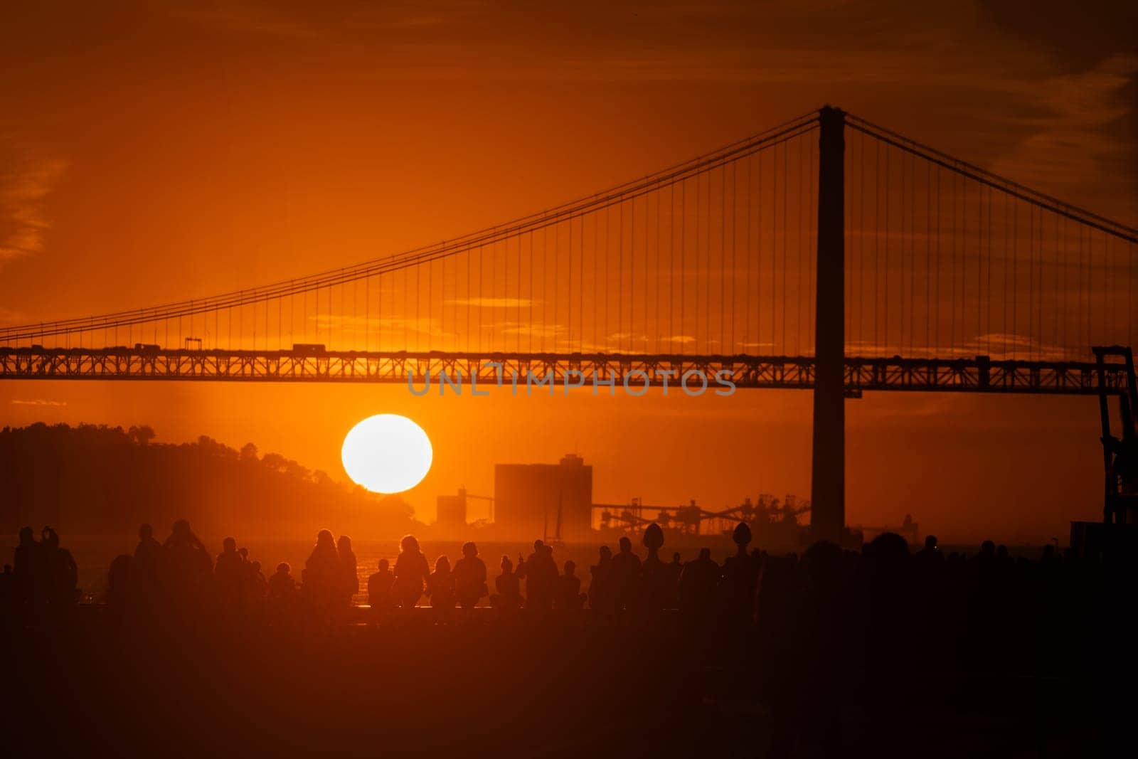 Sunset Serenity: A Majestic Suspension Bridge Bathed in the red Glow of the Setting Sun by Studia72