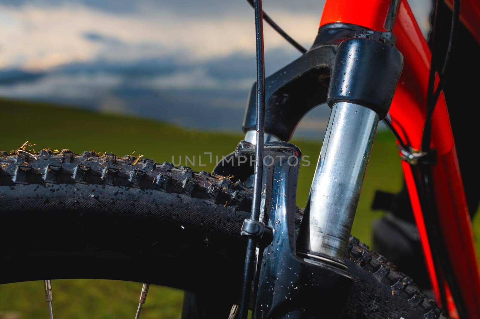 high-speed bicycle disc brake system, perforated disc and caliper, mtb, close-up, mountain bike brake efficiency.