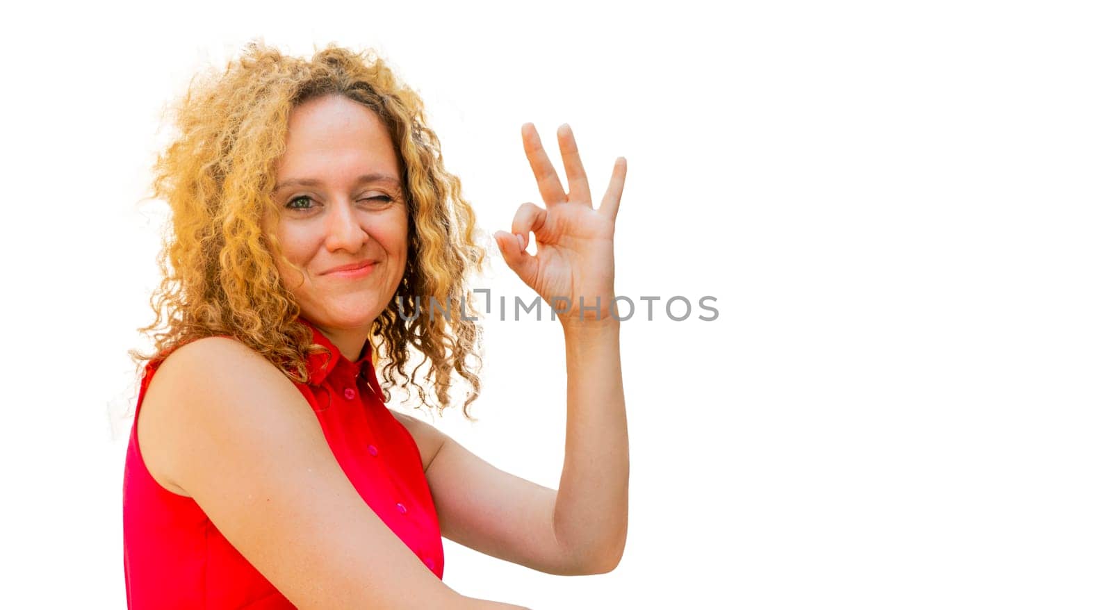 Beautiful fashionable businesswoman smiling making and showing ok hand sign fingers winking with one eye