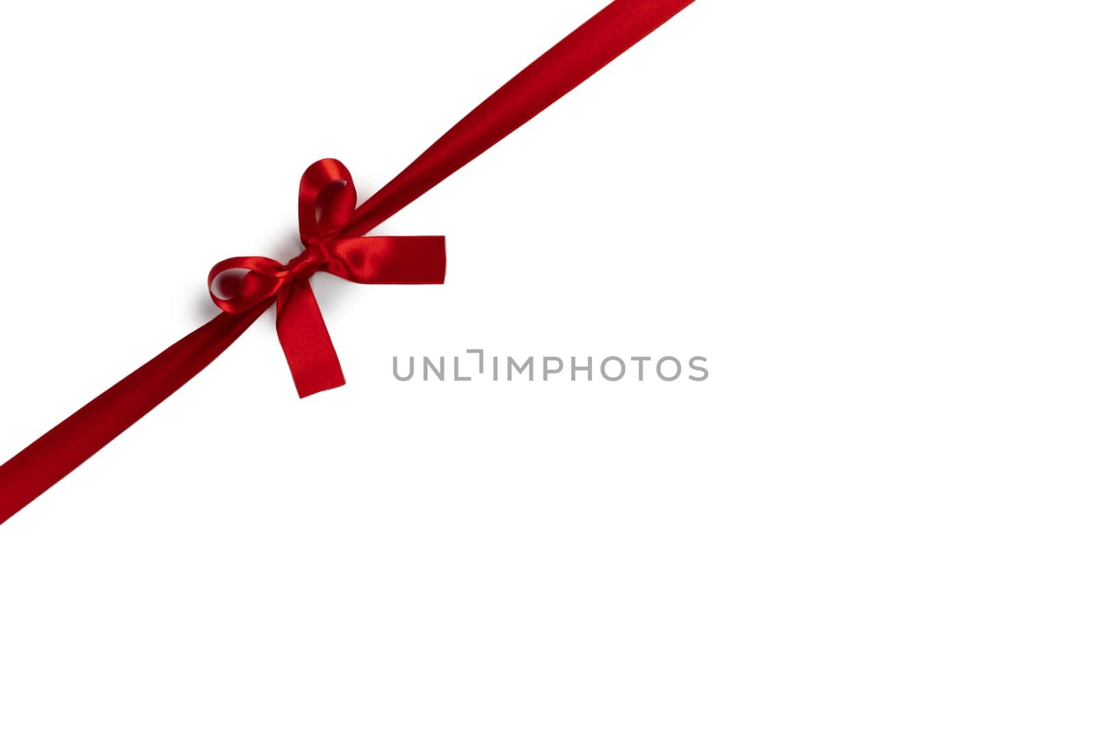 Red satin ribbon bow isolated on white background