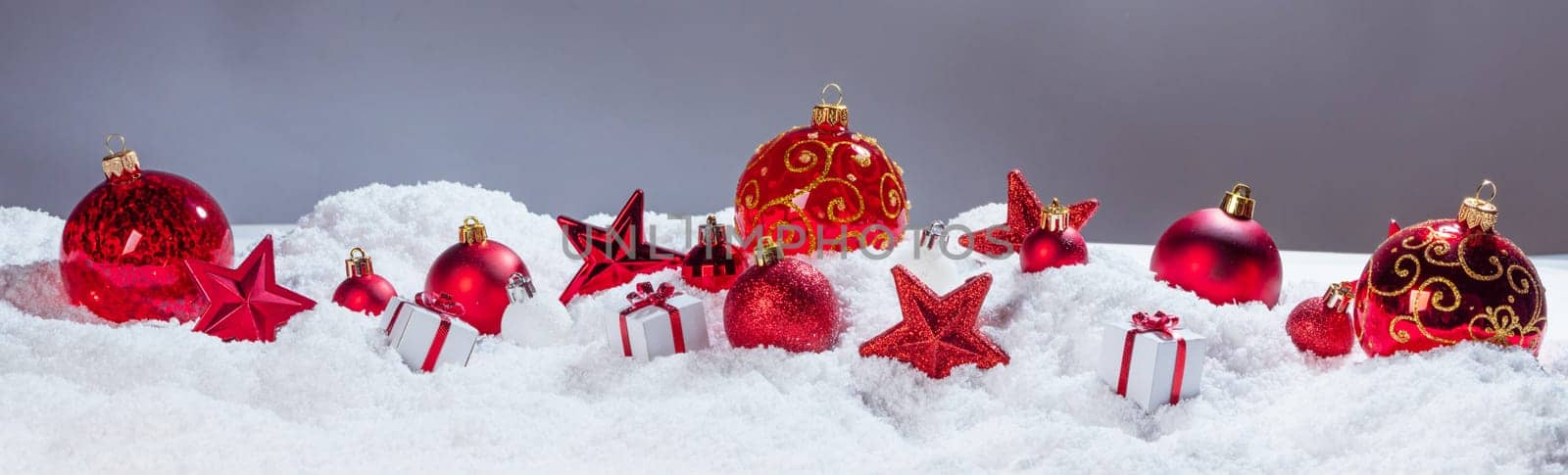 Christmas decoration frame of balls stars and gifts in snow in a row background copy space for text design element