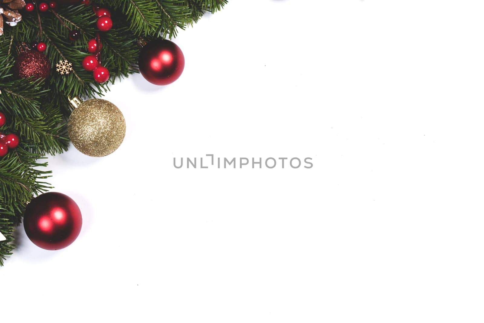 Christmas tree branches and decoration baubles isolated on white background as a border or template for christmas card