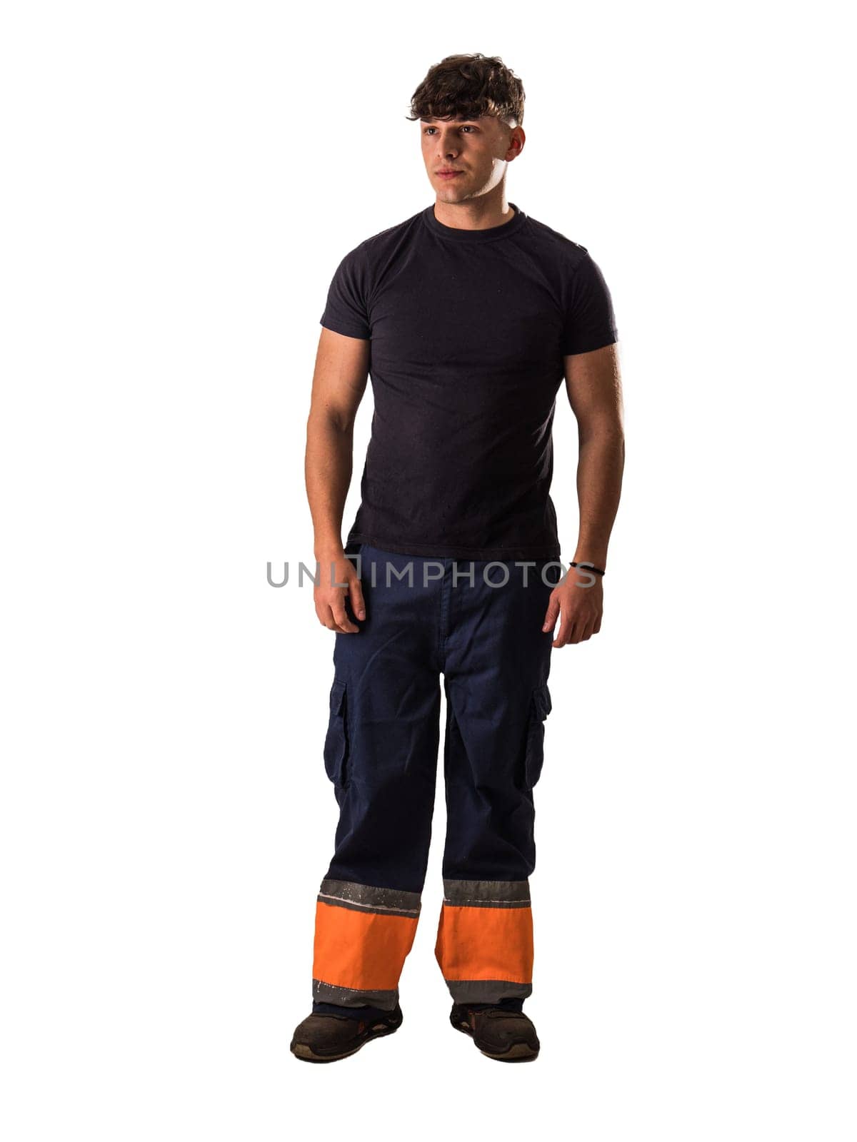 A young man wearing a worker overalls, isolated on white in studio shot. Full length