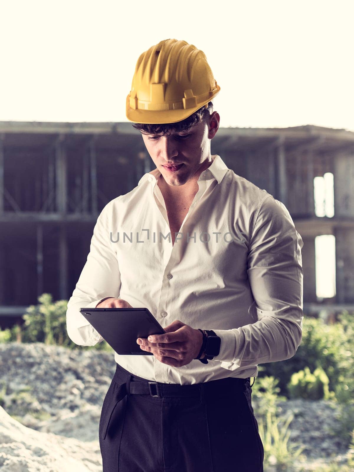 Man in Hard Hat With Tablet by artofphoto