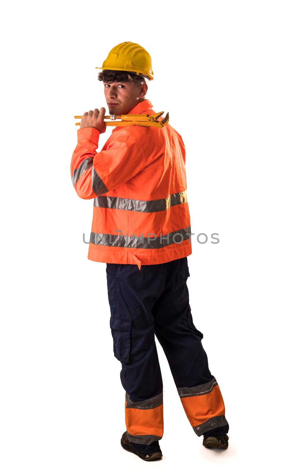 A man in an orange safety jacket holding a wrench