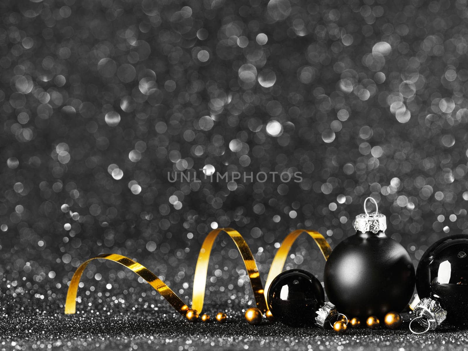 gold and black christmas balls on black bokeh by Yellowj