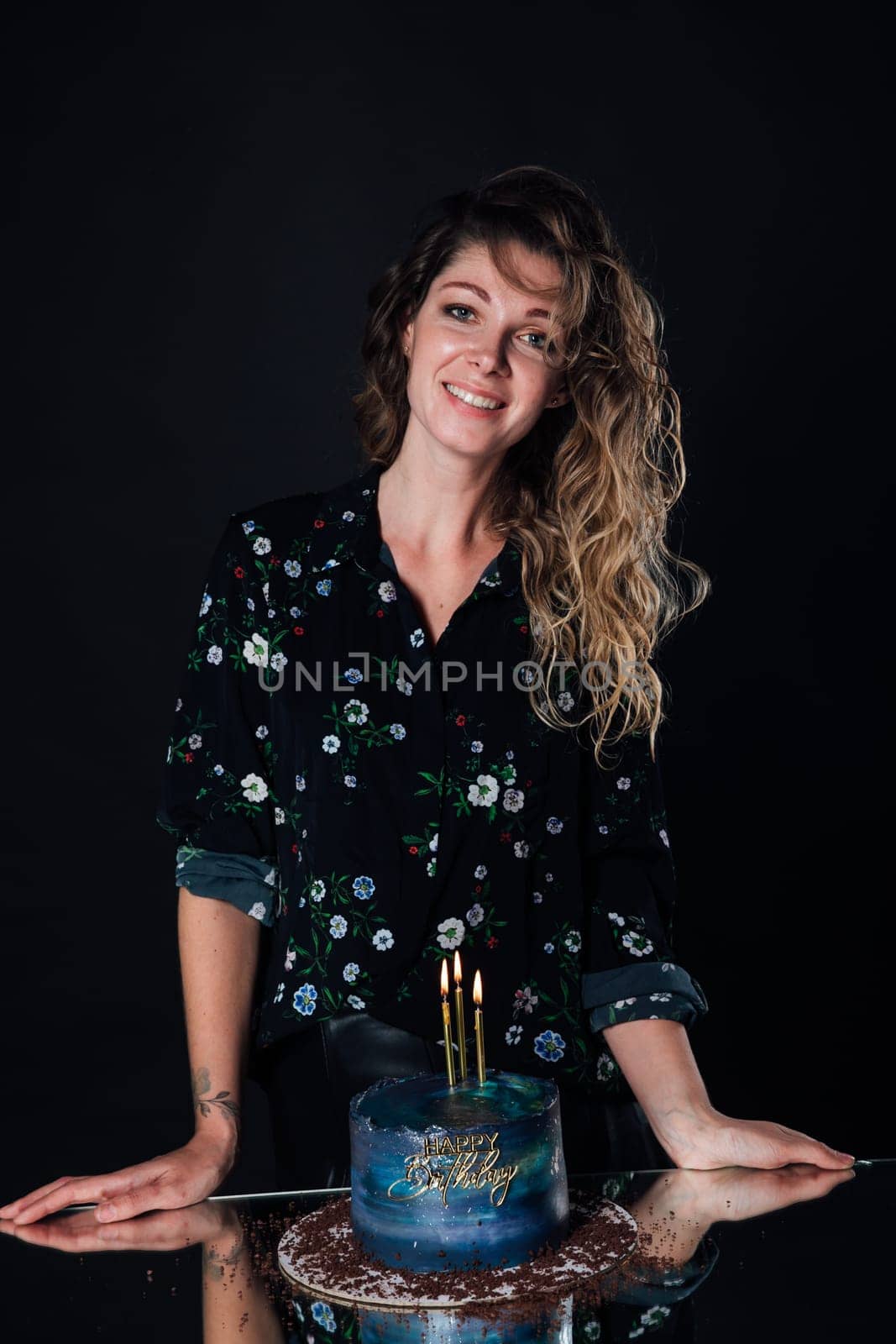 a woman stands with a cake in candles for birthday party dessert sweets by Simakov