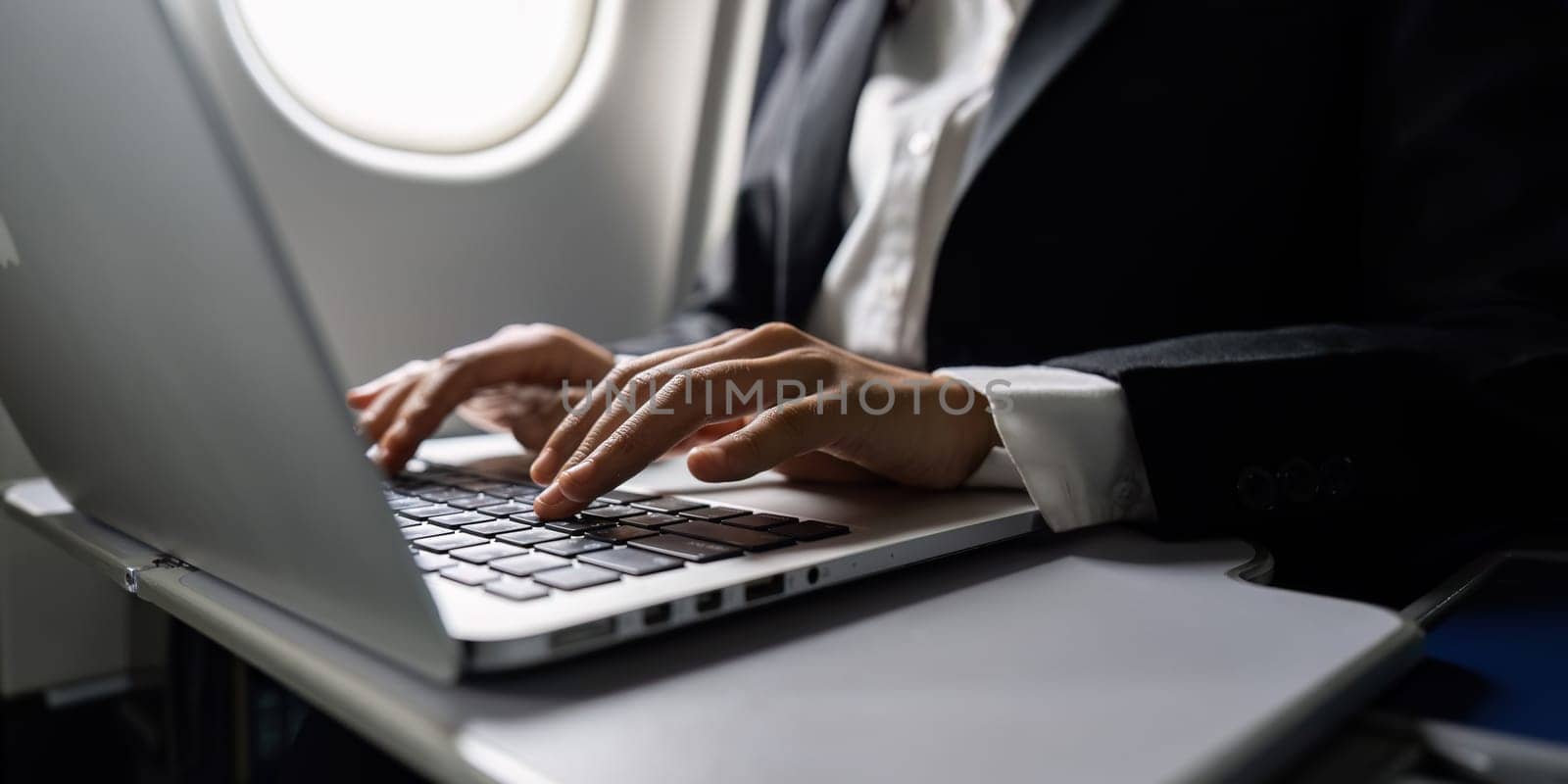 Beautiful Asian businesswoman working with laptop in aeroplane. working, travel, business concept.