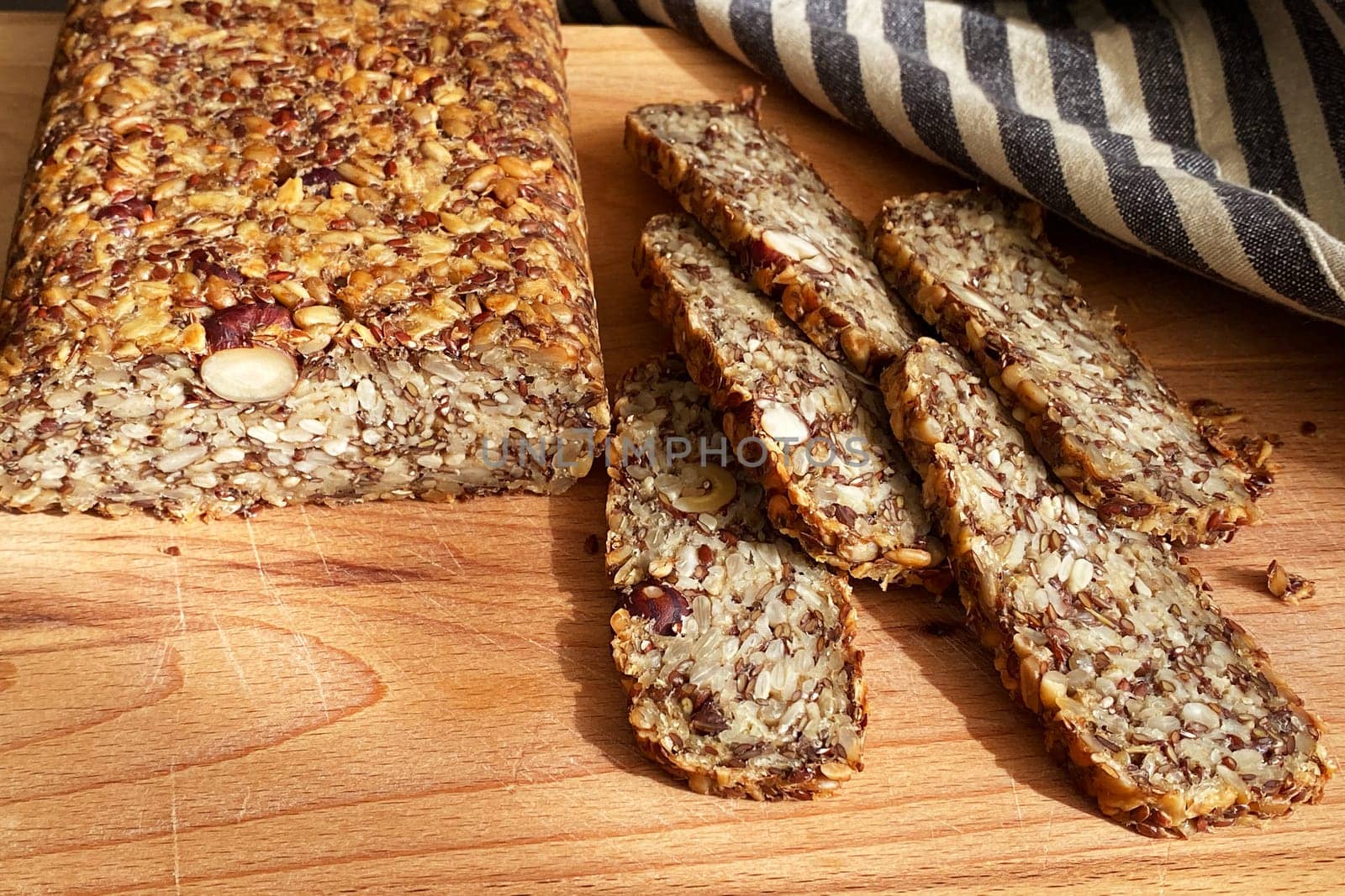 Homemade glutenfree bread with hazelnut and flax seeds on a wooden Board background close-up. Food for diet and health. Healthy almond bread, Keto, ketogenic diet, paleo, low carb fat.