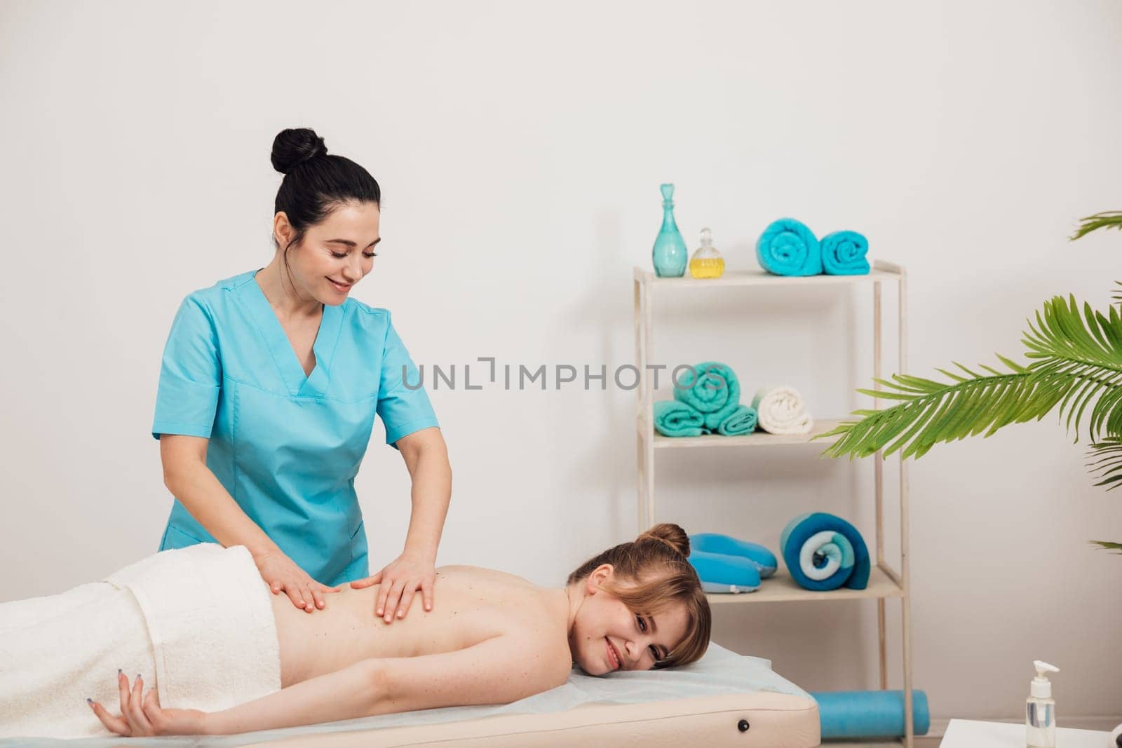 woman masseur does back massage with hands in the room relax relaxation by Simakov