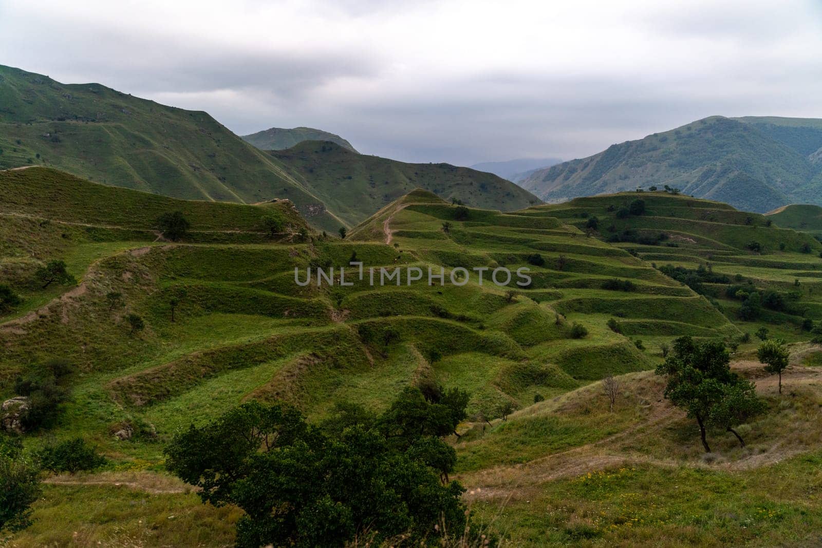 Chokhsky terraces Dagestan. Landscape of mountainous Dagestan with terraced fields and peaks mountains in the distance. by Matiunina