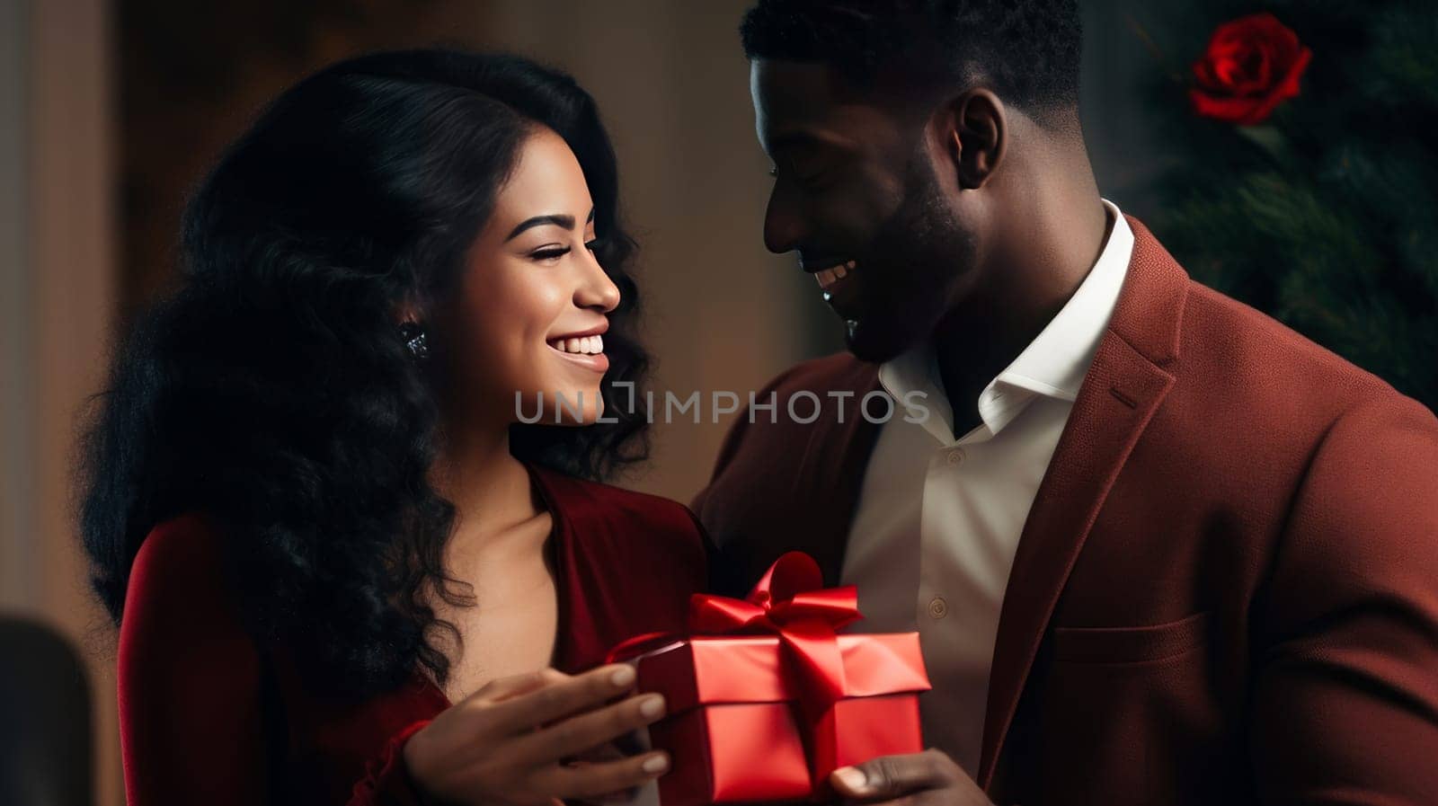 A young African-American black couple with curly hair in love, a man and a woman. A chic, happy man gives a gift in a box to a beautiful smiling woman, with care and love. by Alla_Yurtayeva