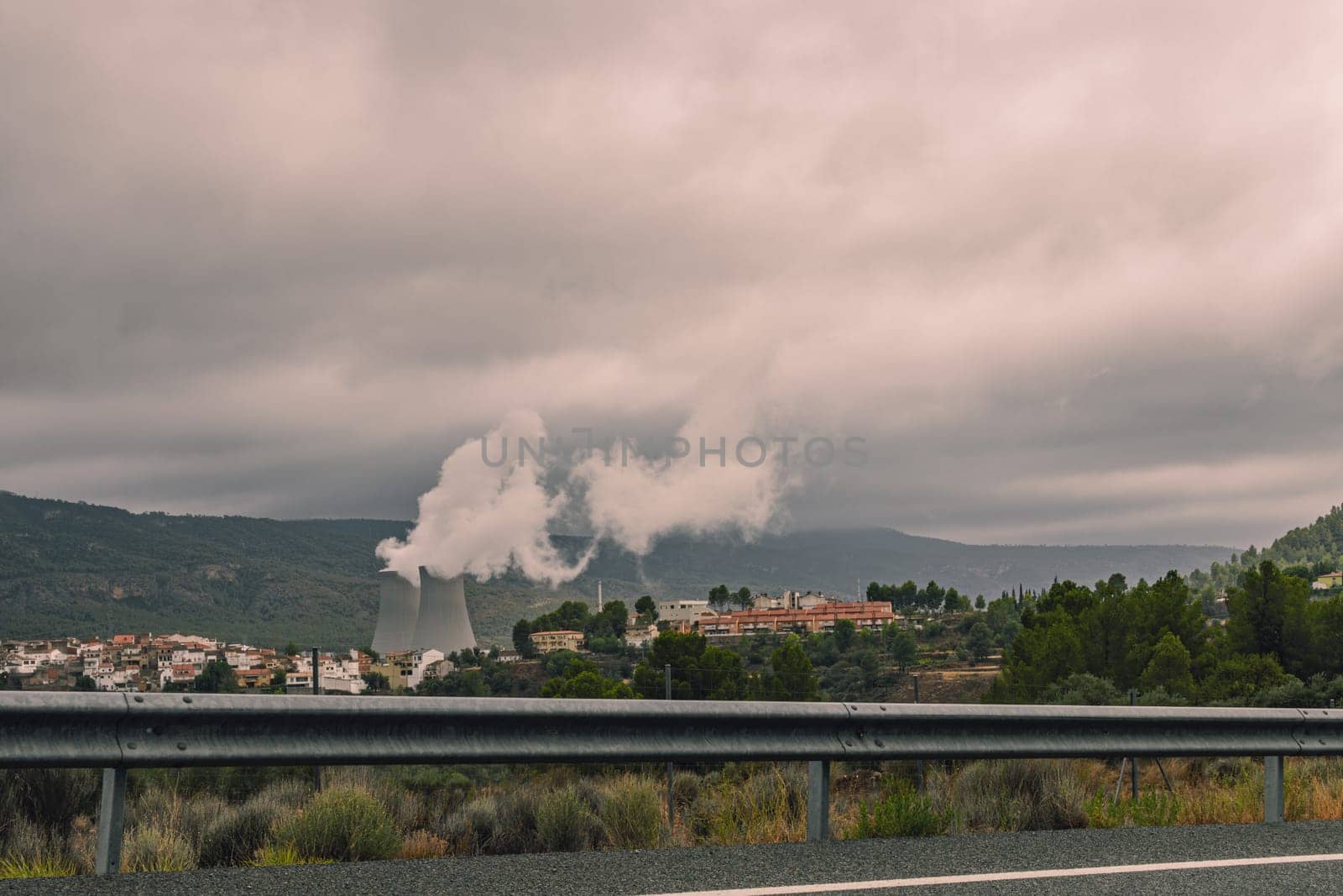 The spanish typical village of Cofrentes, with its castle in the foreground and its nuclear plant  by PopOff