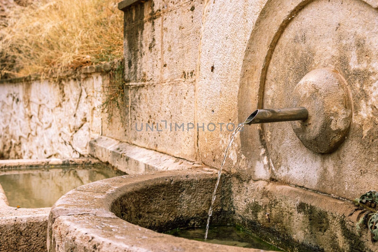 Hearty spring of water in Jesenik mountains. His name is deer spring. Drinking water source for tourists. High quality photo