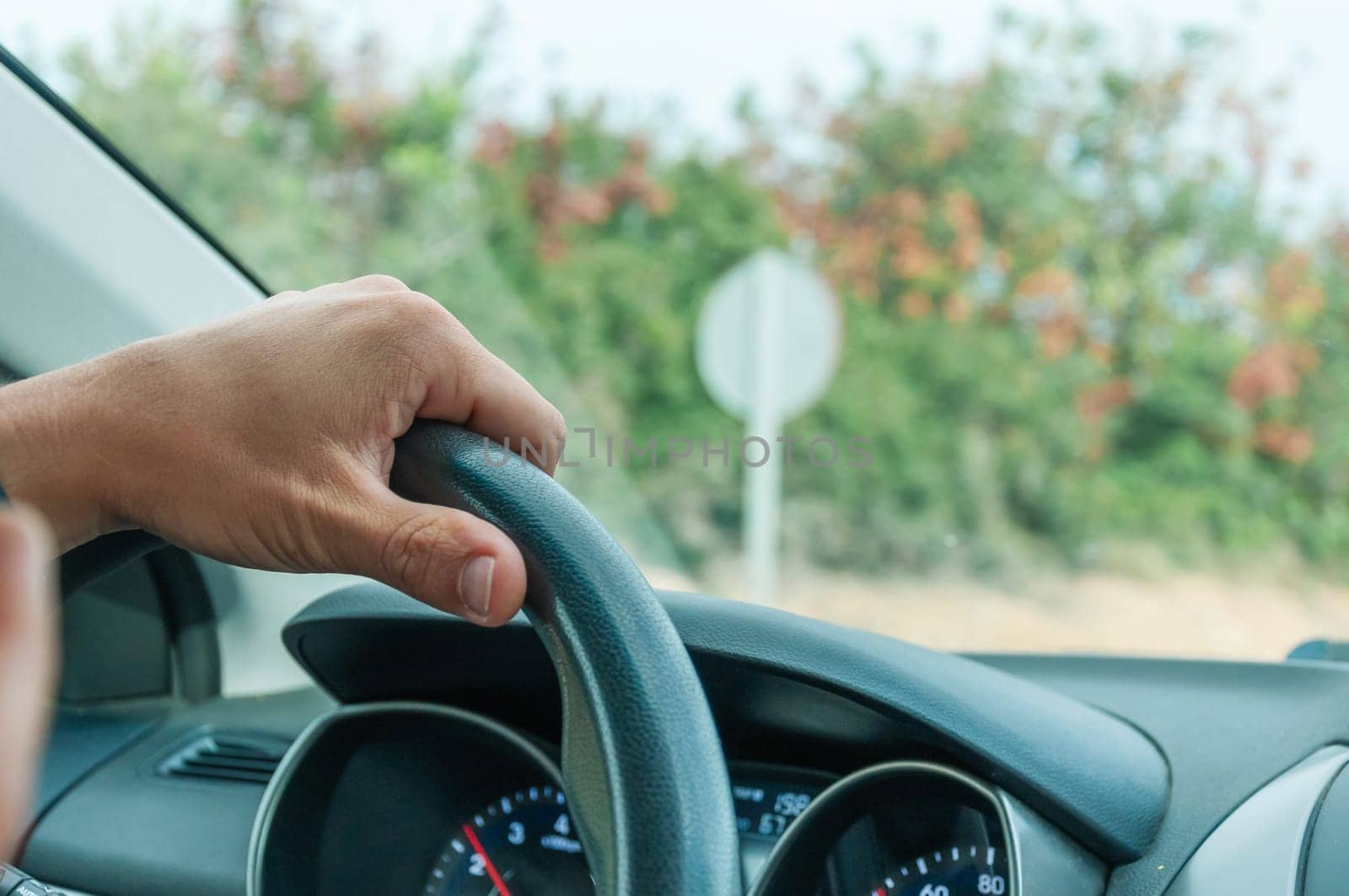 close-up male hands on the steering wheel in the car there is a place for the inscription. High quality photo