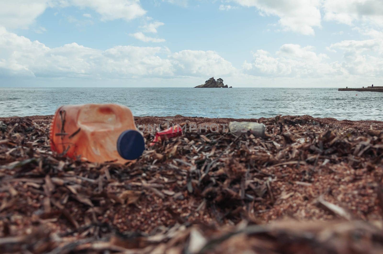 garbage on the seashore, plastic bottles close-up. The concept by PopOff