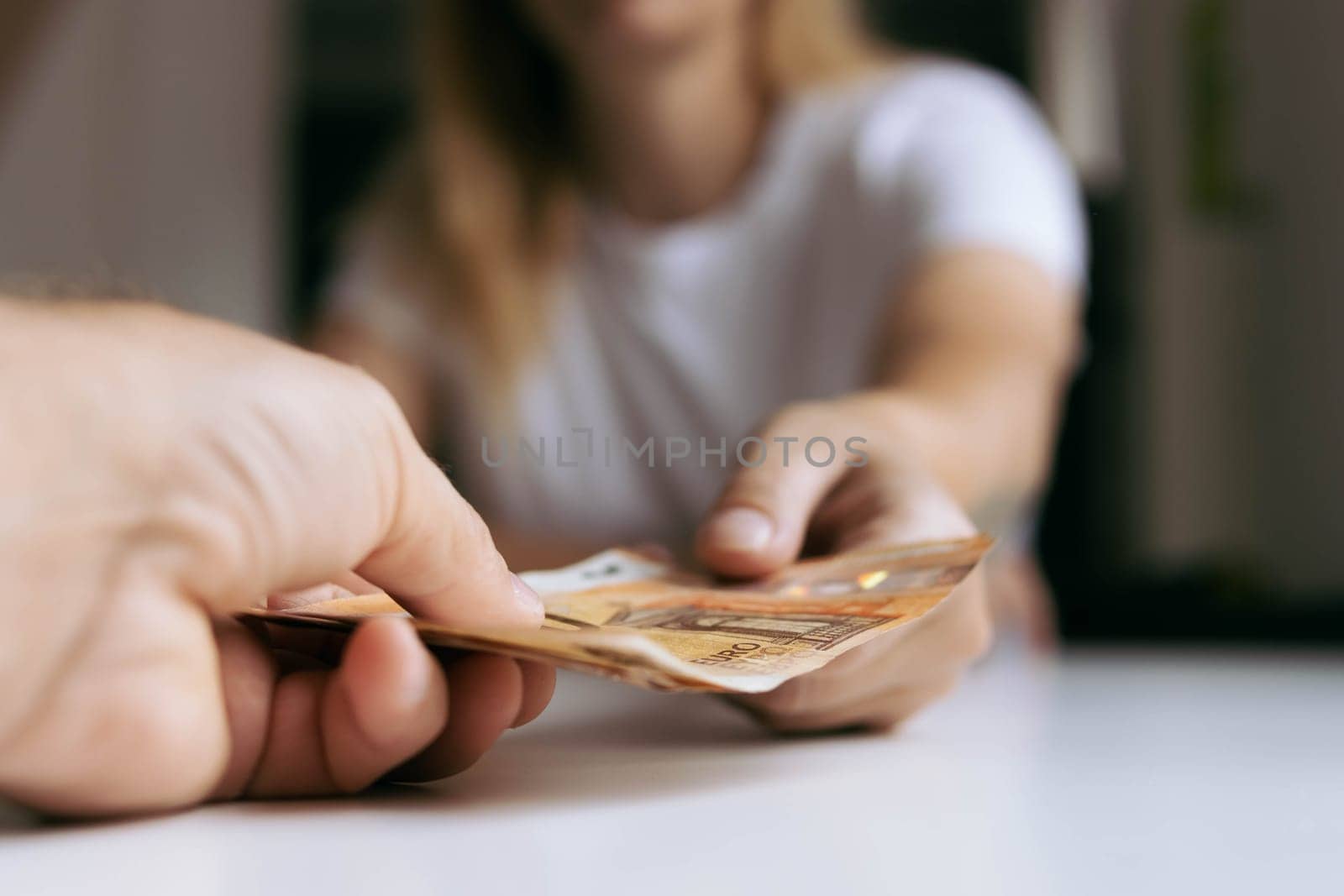 hands men and girl giving money 50 euro.Finance concept.male hand gives 50 euro to female hands. High quality photo