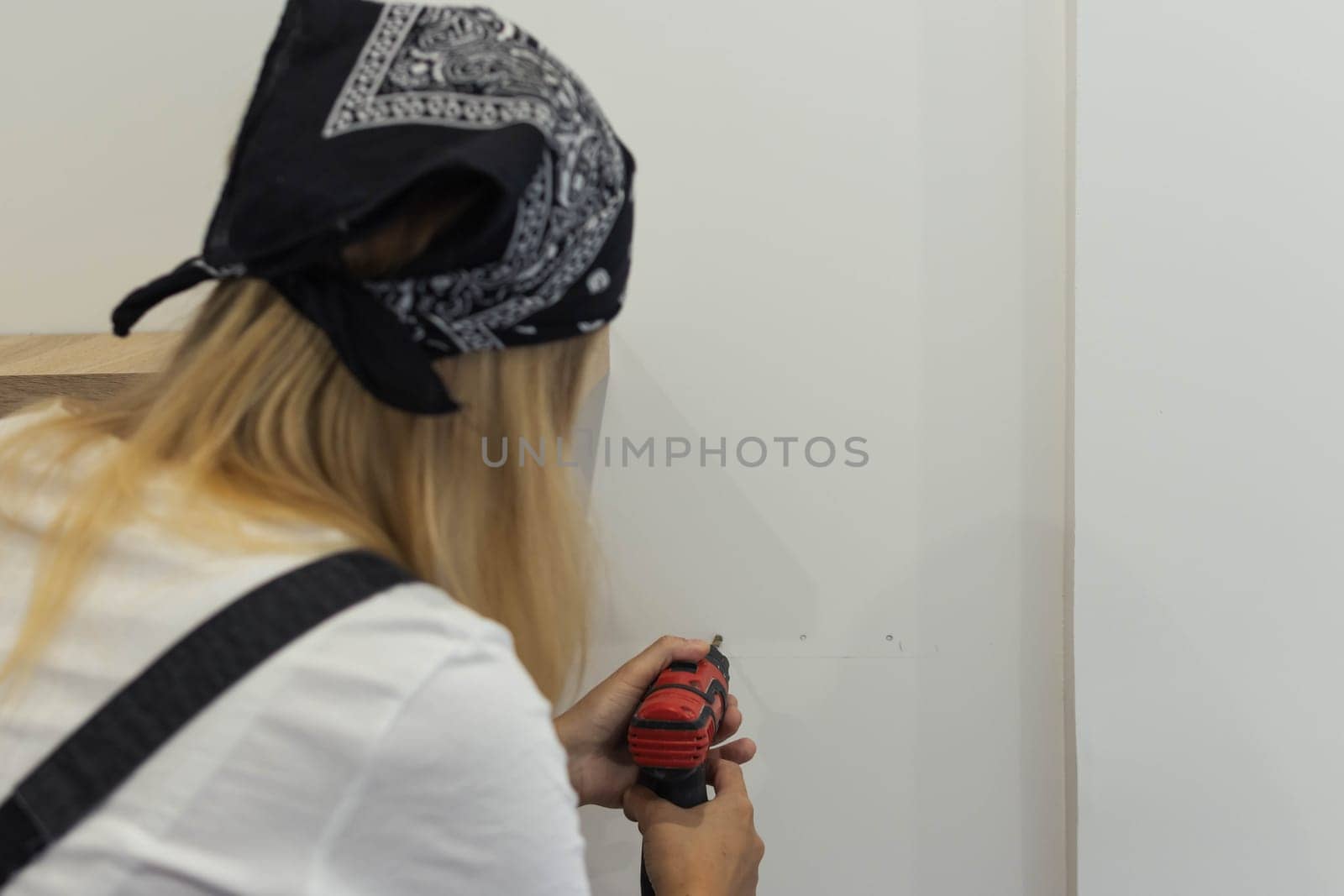 a beautiful girl of European appearance with blond hair in a black bandana, white t-shirt and by PopOff