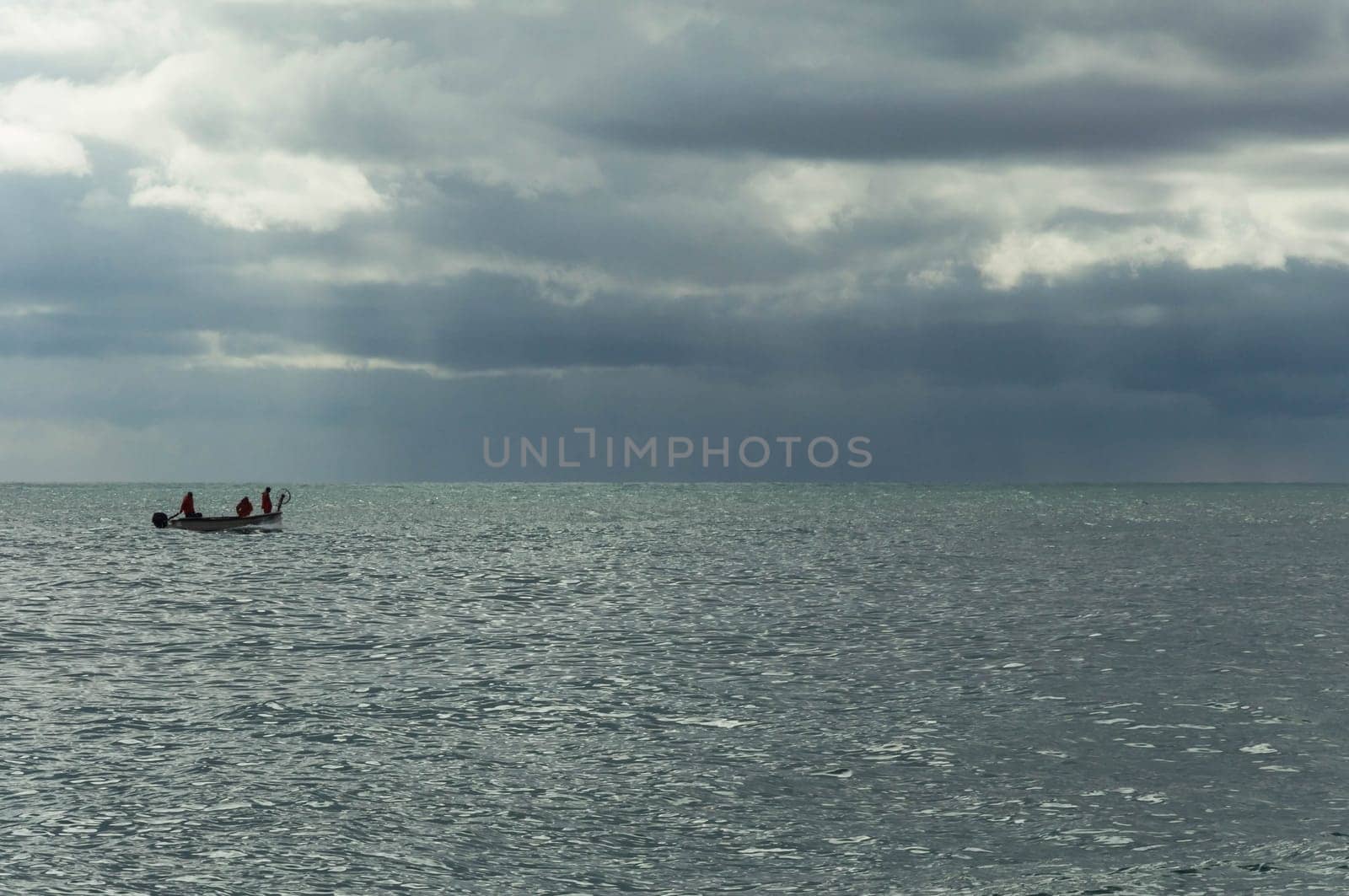 sea view, a boat with people in the distance. Landscape view of the sea and sky, on the right there is a place for an inscription. High quality photo