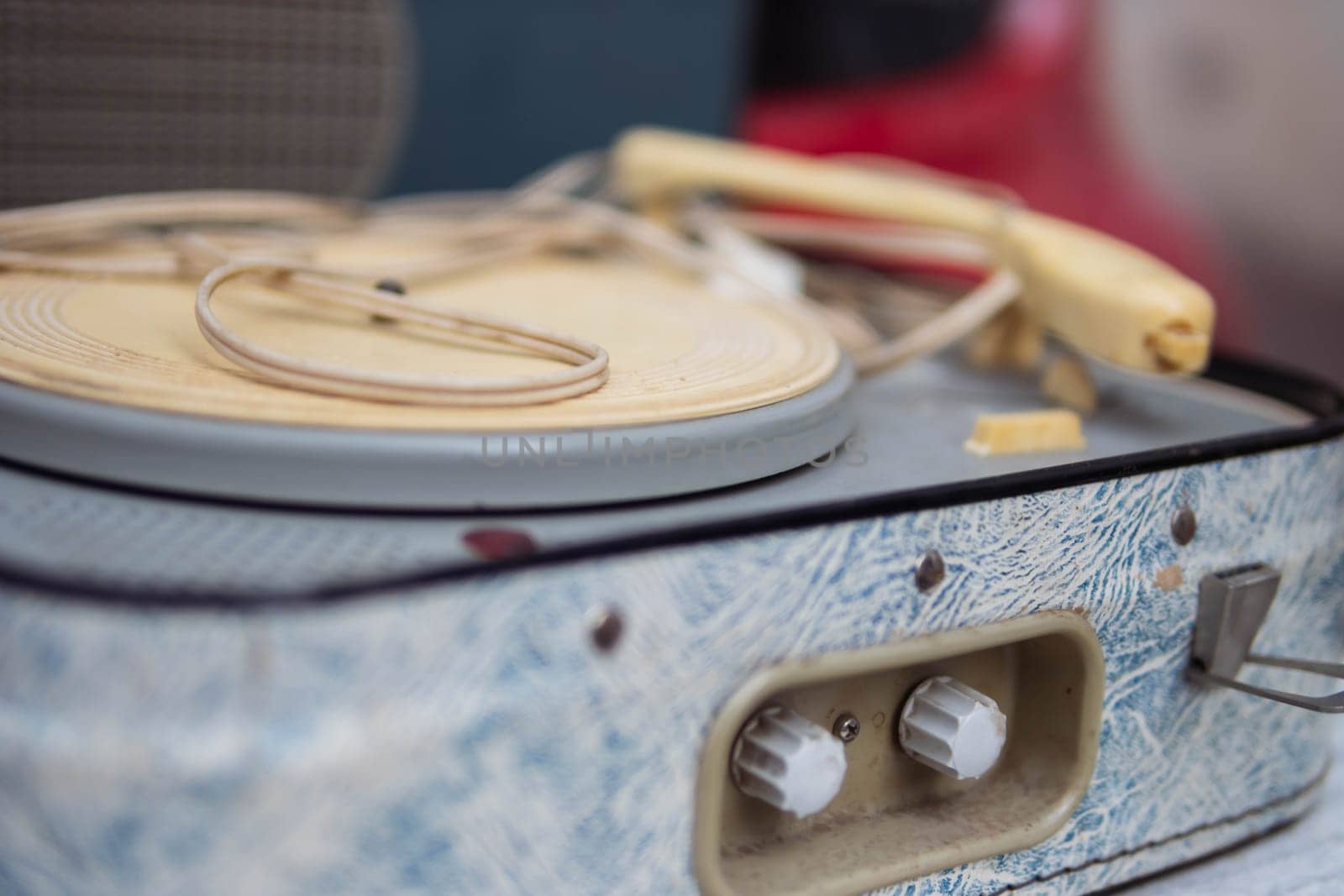 antique turntable for vinyl discs on the table in the room close-up.blue color turntable by PopOff