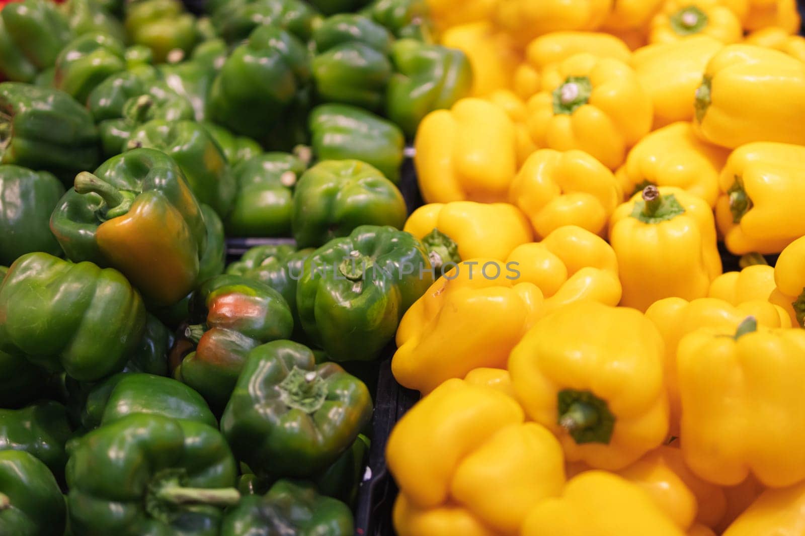 lettuce pepper yellow and green color, in the supermarket for sale. Pepper beautifully laid out on the counter. The concept of healthy eating and veganism. High quality photo