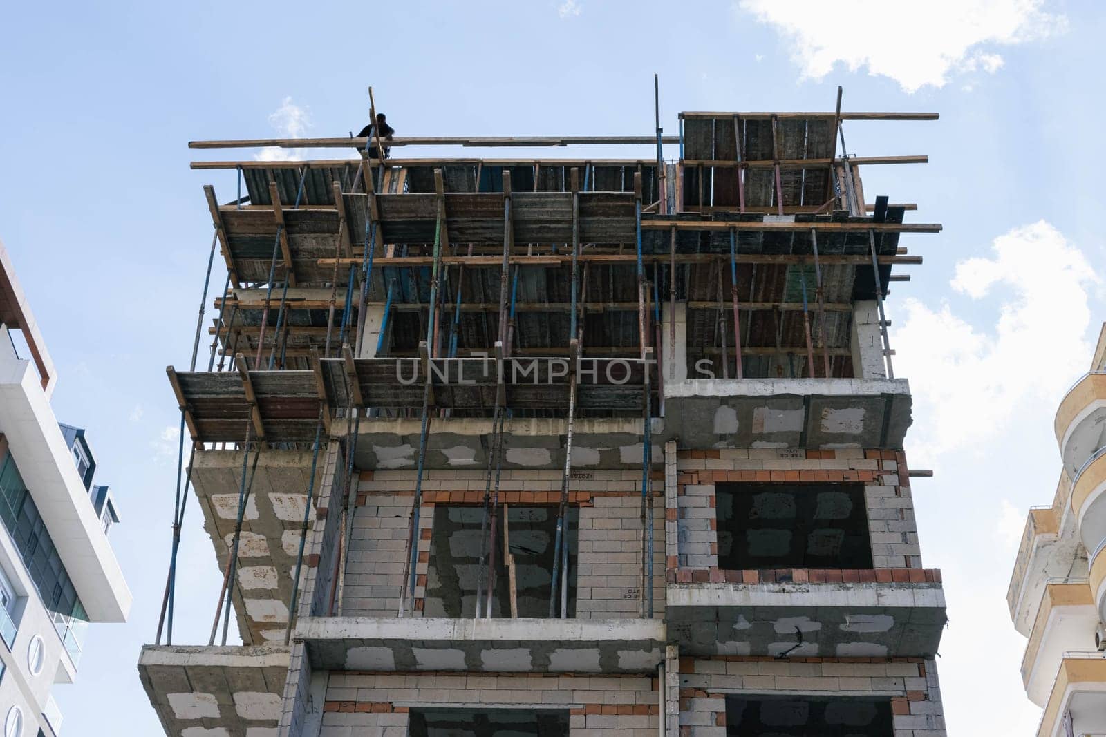 construction of a multi-storey building by a team of builders in the city. Construction concept. High quality photo