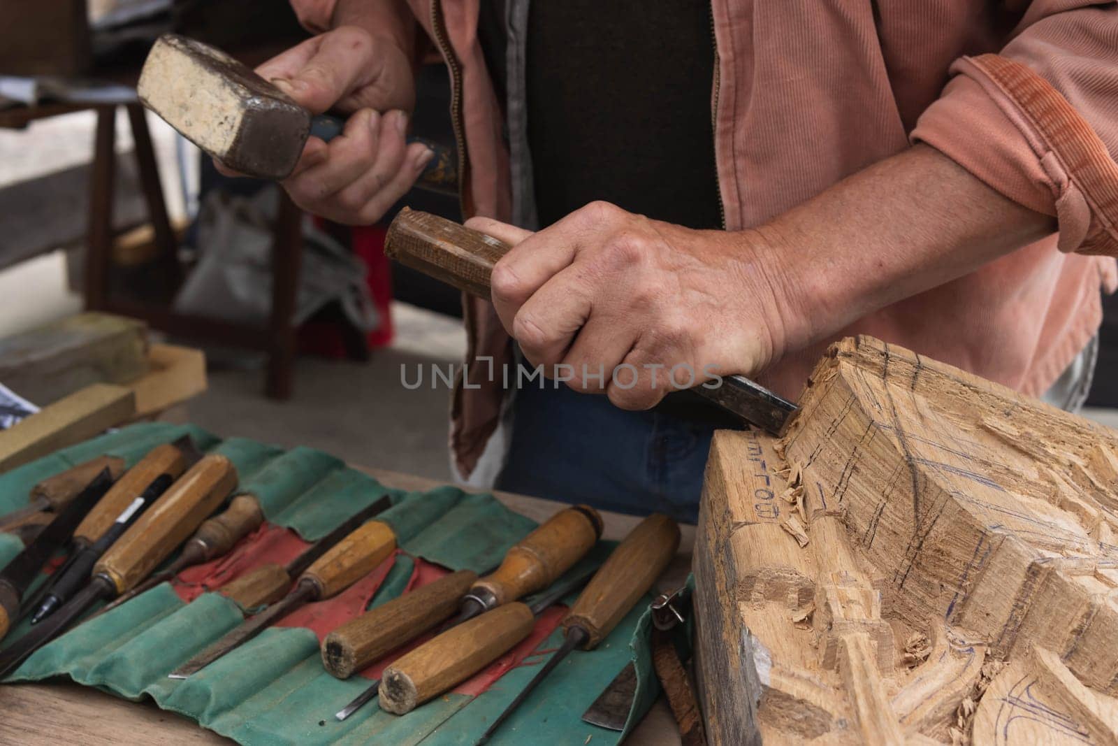 a man makes products from a tree with his own hands and with a tool close-up of a hand a tree. High quality photo