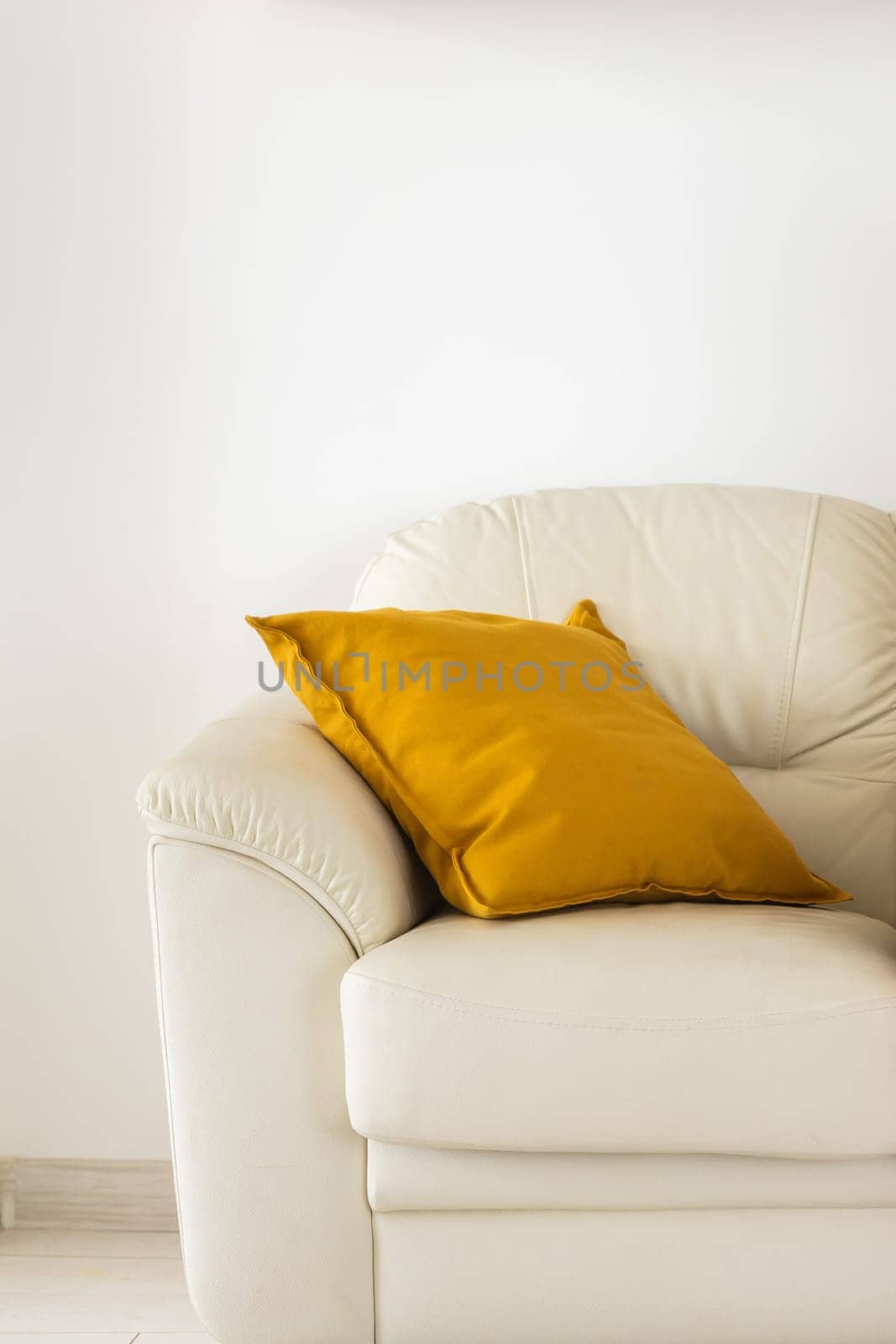 Close up soft yellow pillow on beige sofa - interior detail concept by Satura86