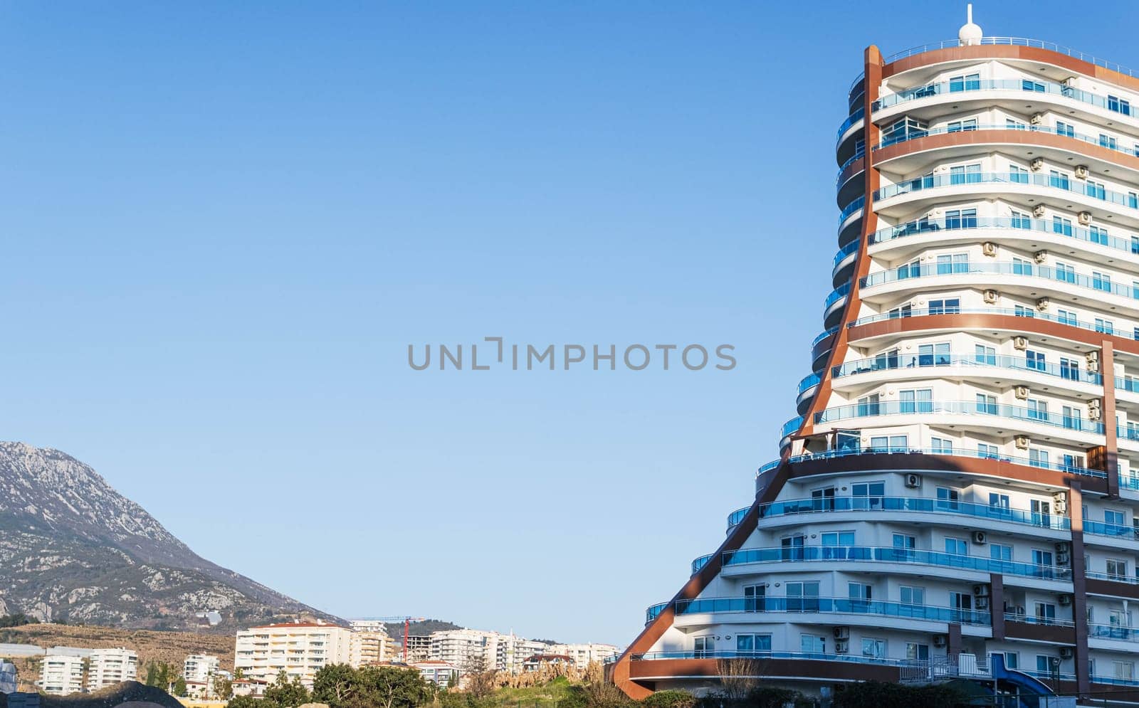 Turkey, Mahmutlar March 20, 2022 a large building of unusual shape on the left there is a place by PopOff