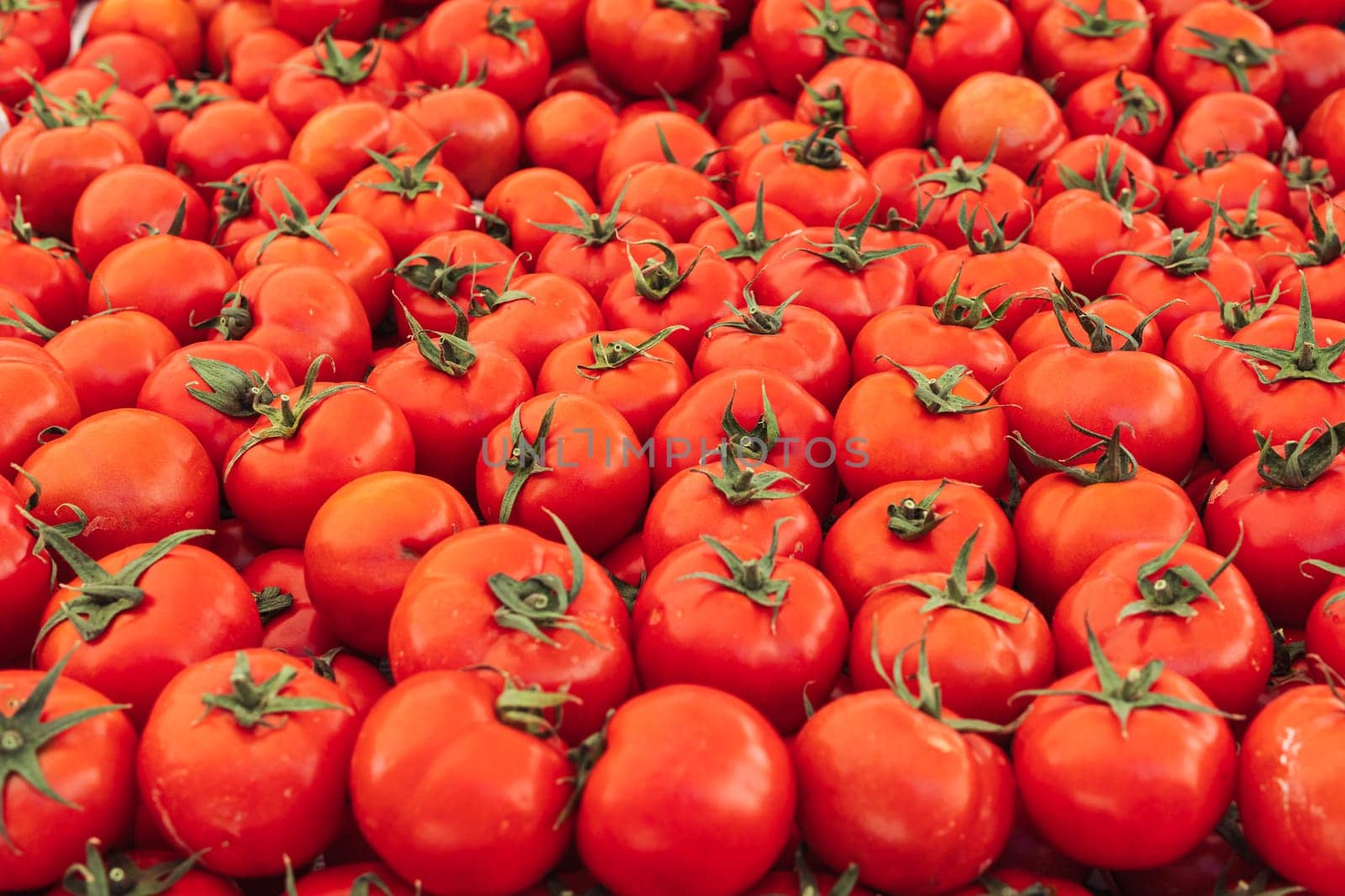 a lot of tomatoes on the market on the counter, the background by PopOff