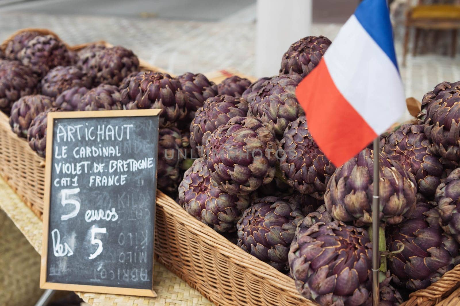 a lot of artichokes close-up. Artichokes are sold on the showcase, healthy food. Photo angle from. by PopOff