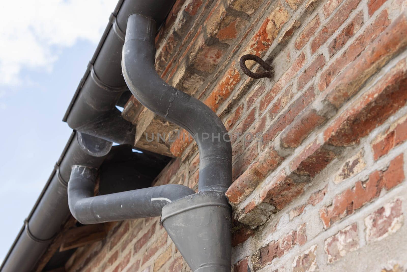 Vintage gutter, downspout, downspout is a pipe to carry rainwater out of the gutter. For the accumulation and storage of rainwater for reuse on site. High quality photo