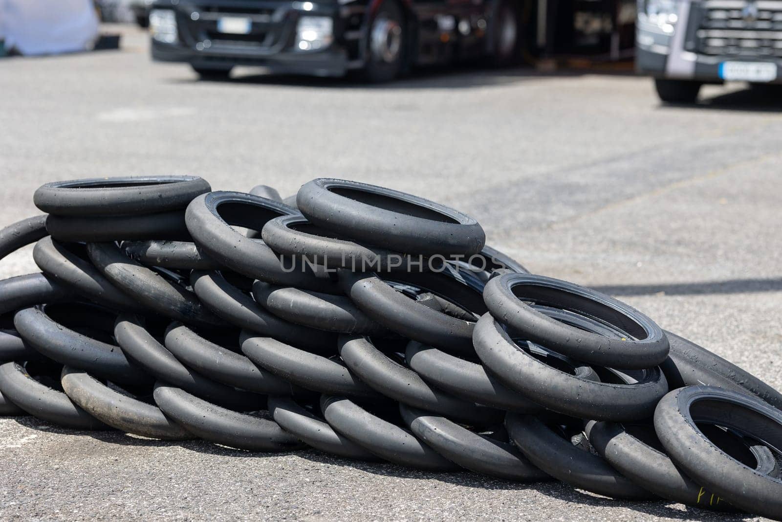 A Towering Stack of Rubber: A Pile of Tires in the Center of a Parking Lot by Studia72