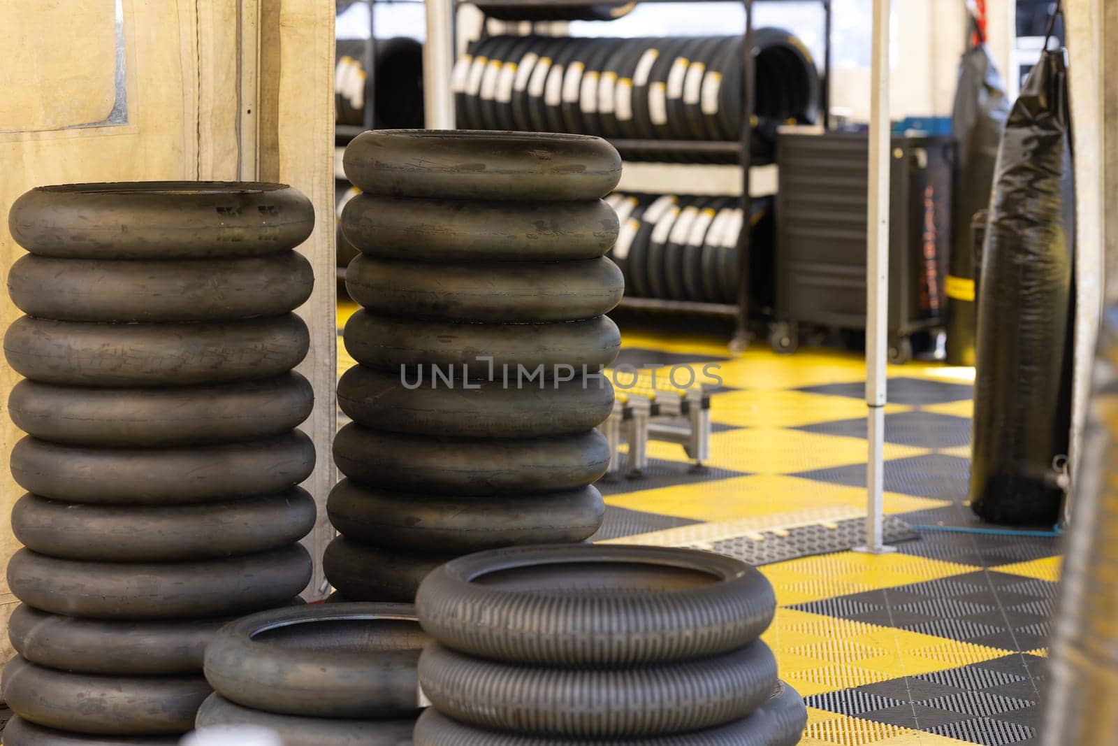 A pile of tires sitting on top of a checkered floor